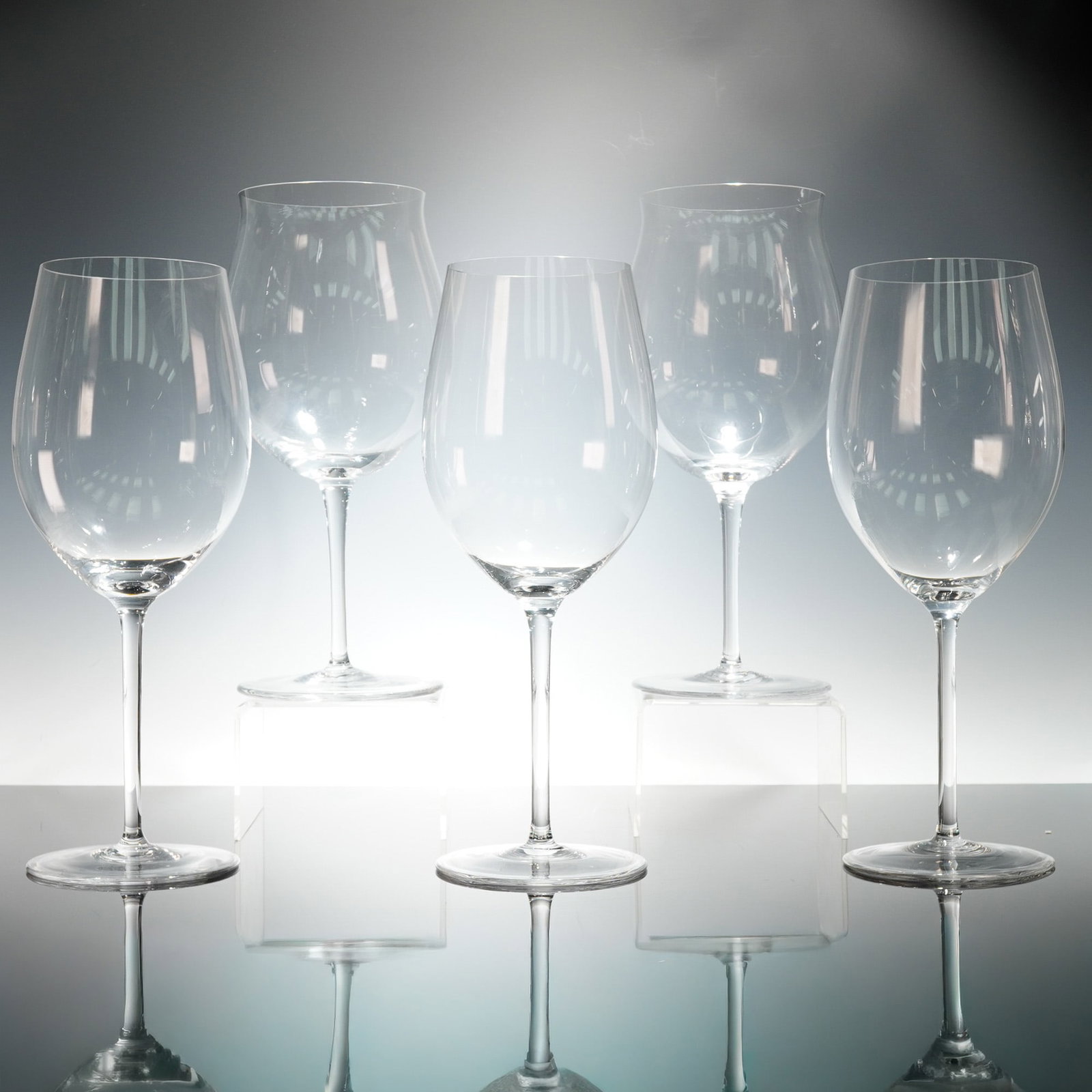 5pc Riedel Giant Crystal Wine Glasses for Display: Collection of crystal wine glasses in two complementary styles, ranging in height from approximately 15.5 to 16.5 inches. Each glass is mouth-blown with elegantly thin walls and elongated stems, desig
