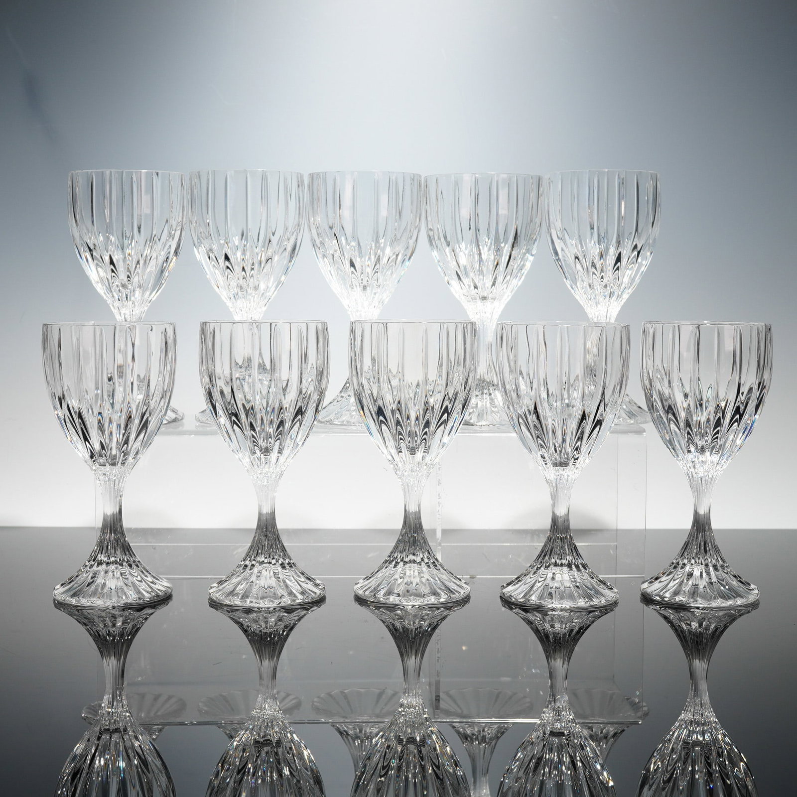 10pc Mikasa Park Lane Crystal Water Goblets: Each formed with a rounded bowl decorated by evenly spaced vertical flutes that create pronounced light refraction, supported by a narrow, tapered stem that transitions into a wide, flared foot showca
