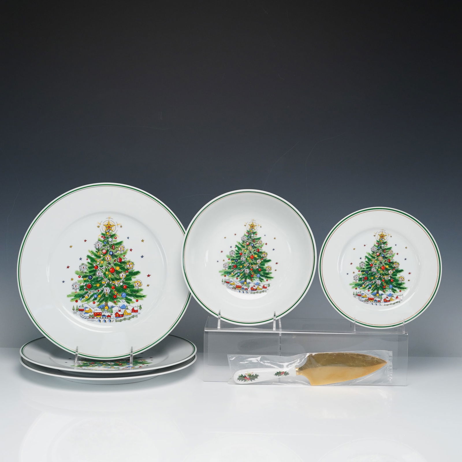 7pc Salem Christmas Eve and Queens Yuletide Serveware Set: A coordinated 7-piece holiday-themed group including porcelain tableware from Salem's Christmas Eve pattern and a Rosina-Queens Yuletide pie and cake server. This lot includes 3 round platters, 1 sala
