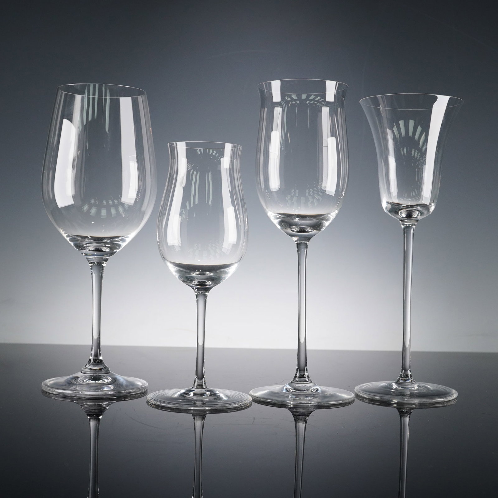 4pc Riedel Crystal Sommeliers Wine Glasses: Riedel crystal wine glasses from the renowned Sommeliers series, each meticulously crafted to enhance the character of specific beverages. The set includes a Bordeaux glass designed with a generous bo