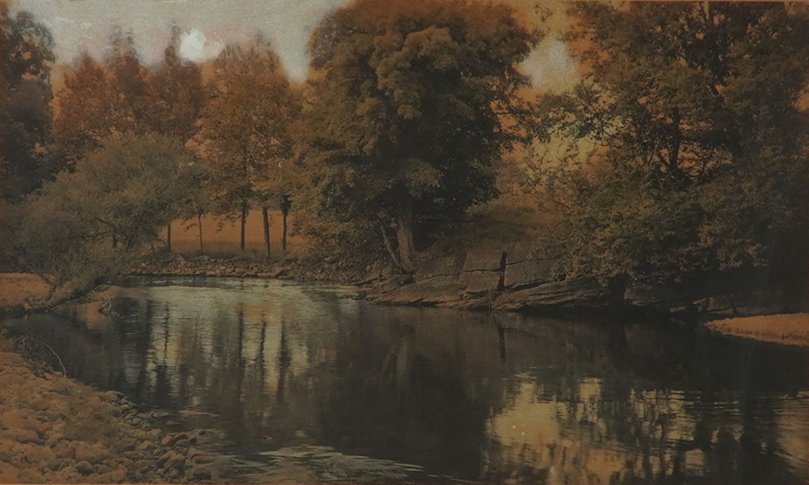 Wallace Nutting (American 1861-1941) Hand-Colored Photograph, Signed: A fine and large hand-colored photograph by Wallace Nutting, titled The Swimming Pool. This quintessential Nutting pastoral depicts a tranquil woodland stream bordered by trees whose autumn foliage is