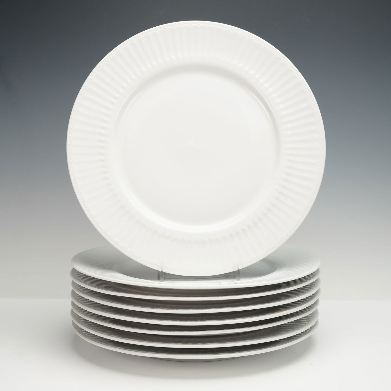 8pc Coventry White Porcelain Dinner Plates, Parthenon: A set of eight white porcelain dinner plates with raised ribbed rims and a clean glossy finish. Coventry backstamp. Dimensions: Each plate: 11.5"L x 11.5"W x 1"H. Country of Origin: China