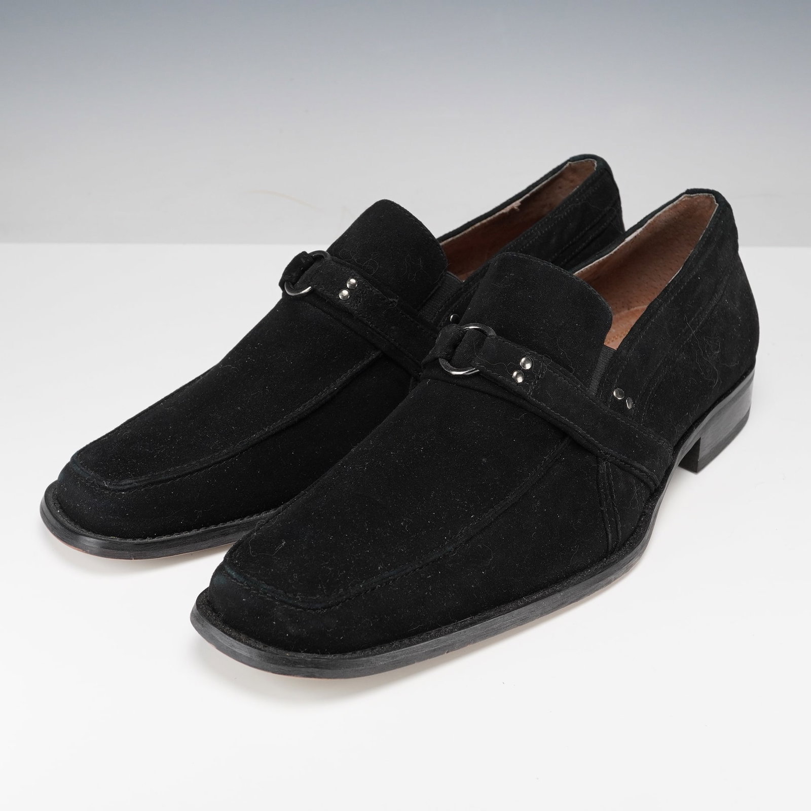 Fratelli Select Vero Cuoio Men's Black Suede Loafers: A distinguished pair featuring a sleek, elongated toe and a refined strap detail accented by polished metal hardware. The interior is lined with soft leather for comfort. Vero Cuoio stamped to the int