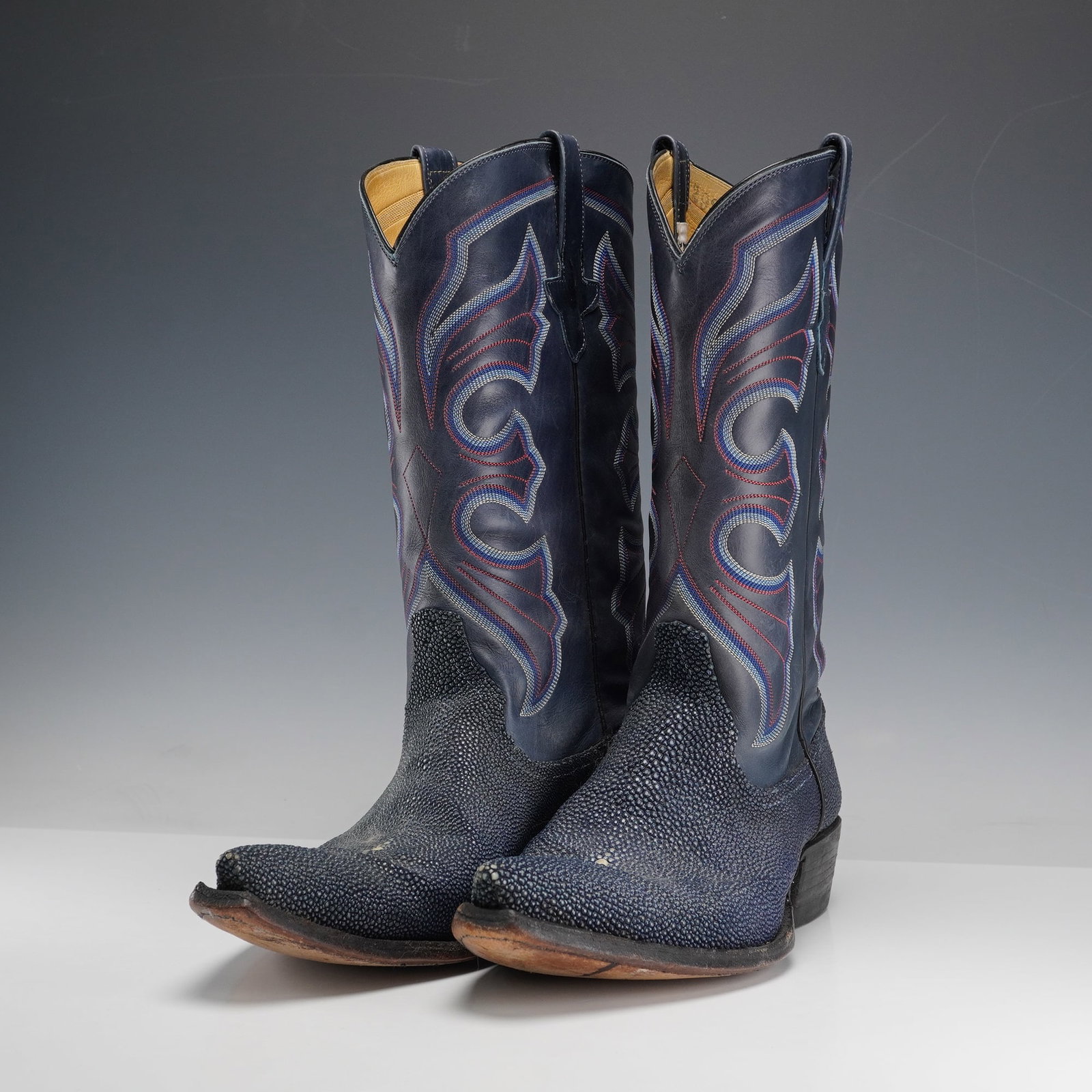 Pair of Billy Martins Leather Cowboy Boots, Blue: Pair of Billy Martins western cowboy boots in stingray blue, with tall shafts featuring decorative stitched motifs, pull straps at the top, and pointed toes with classic stacked heels. Marked 2937E, b
