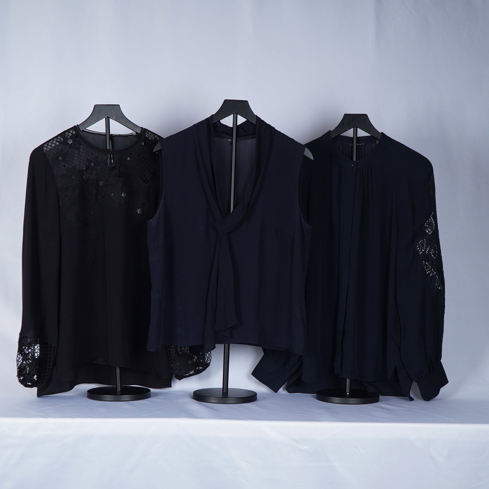 3pc Tahari and Escada Silk Long and Short Sleeve Blouses: Women's blouses in luxurious silk and chiffon blends by Escada and Elie Tahari. Included is a black long-sleeve Tahari blouse with sheer geometric lace detailing at the yoke and cuffs, offering an ele