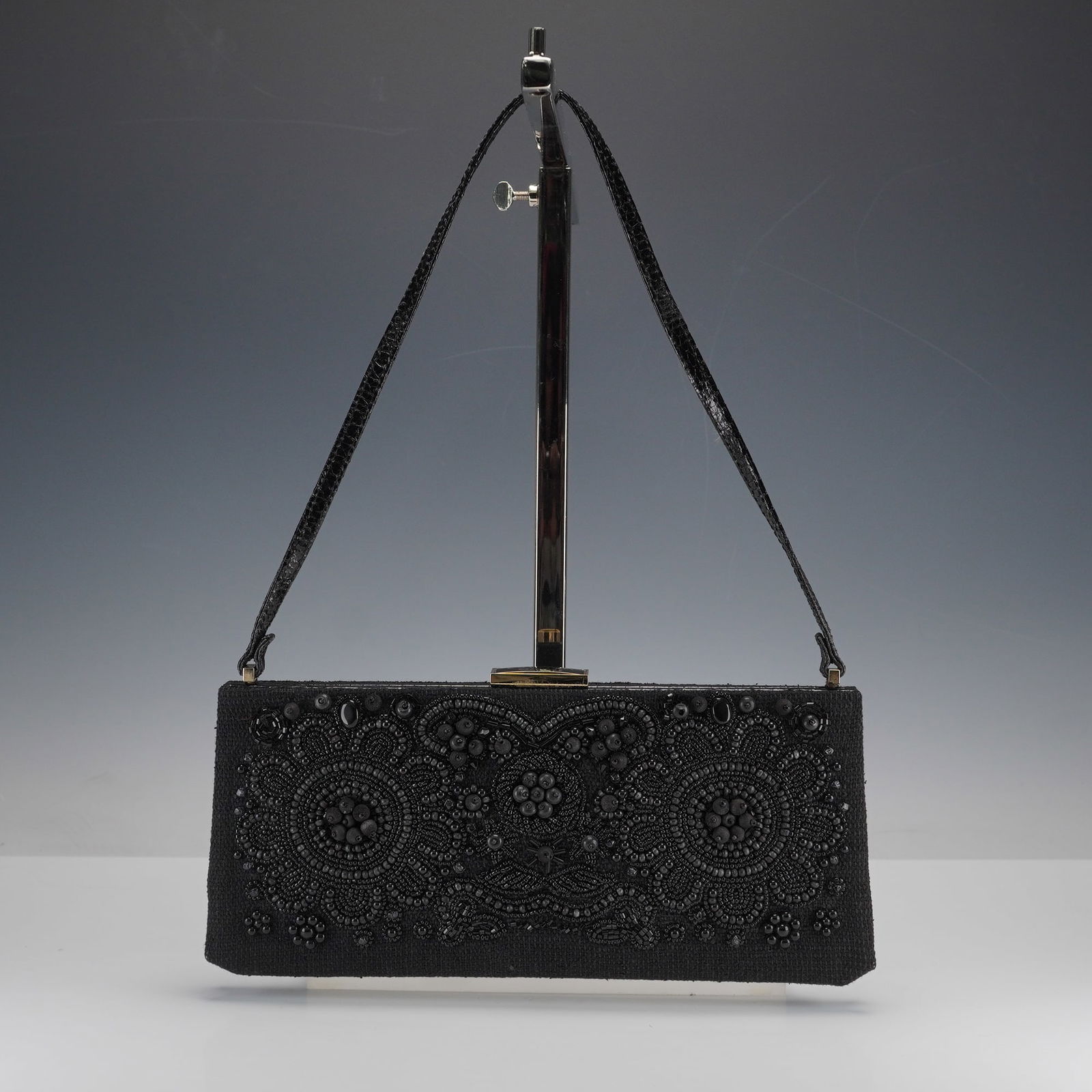 Escada Exotics Black Beaded Evening Bag: Rectangular black textile evening bag with allover bead embroidery in floral and scroll motifs, featuring a mix of smooth glass and matte wooden-style beads. Includes a patent leather strap, gold-tone