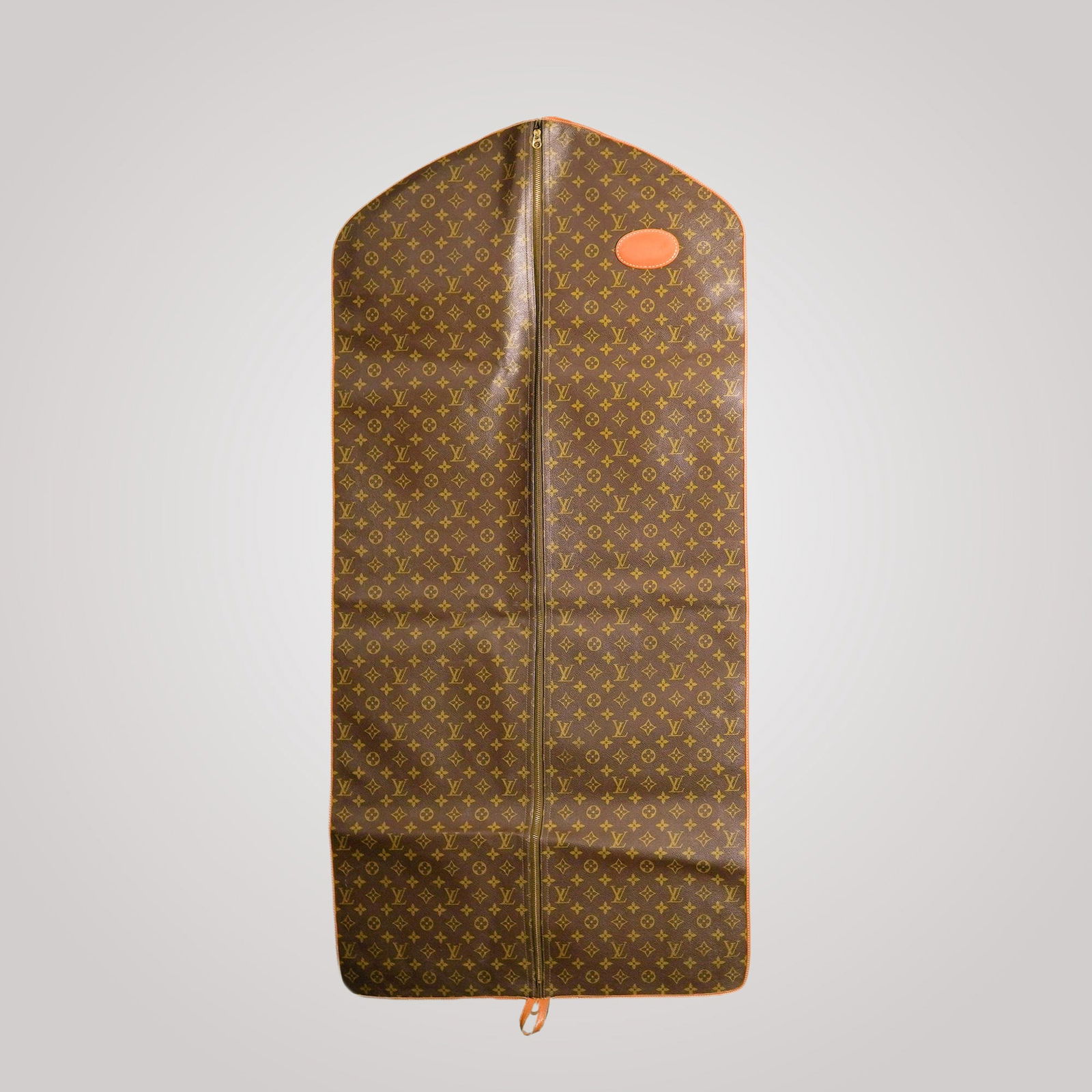 Louis Vuitton Monogram Garment Bag: This vintage Louis Vuitton Monogram garment bag is crafted from the iconic Monogram canvas with leather trim and brass hardware. It features a two-way zipper closure and a hanging hook for easy storag