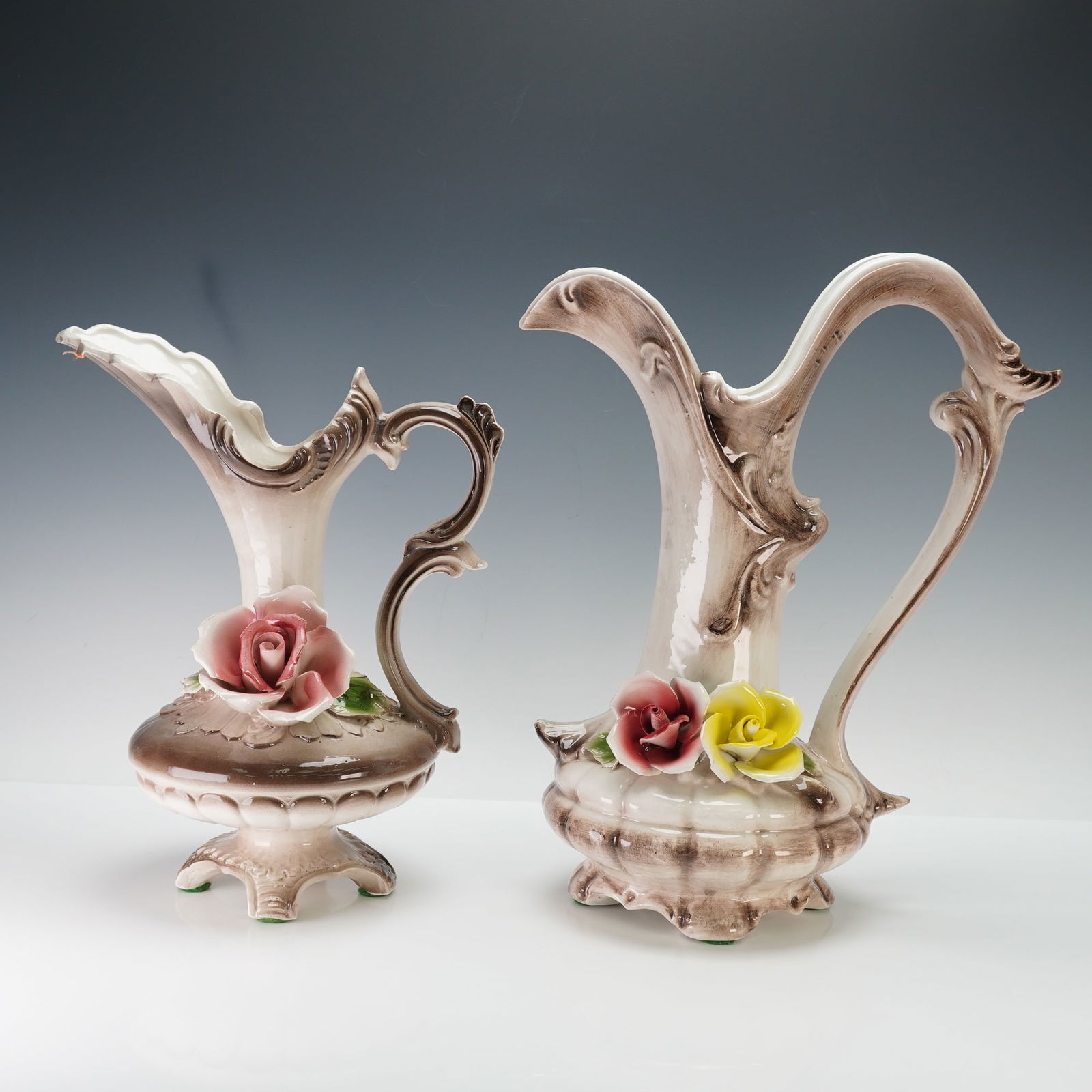2pc Capodimonte Hand-Painted Floral Vase & Pitcher: Elegant Italian porcelain set featuring two Rococo-style vessels with gracefully curved handles, scalloped rims, and delicately molded bases. Each piece is adorned with hand-applied porcelain roses in
