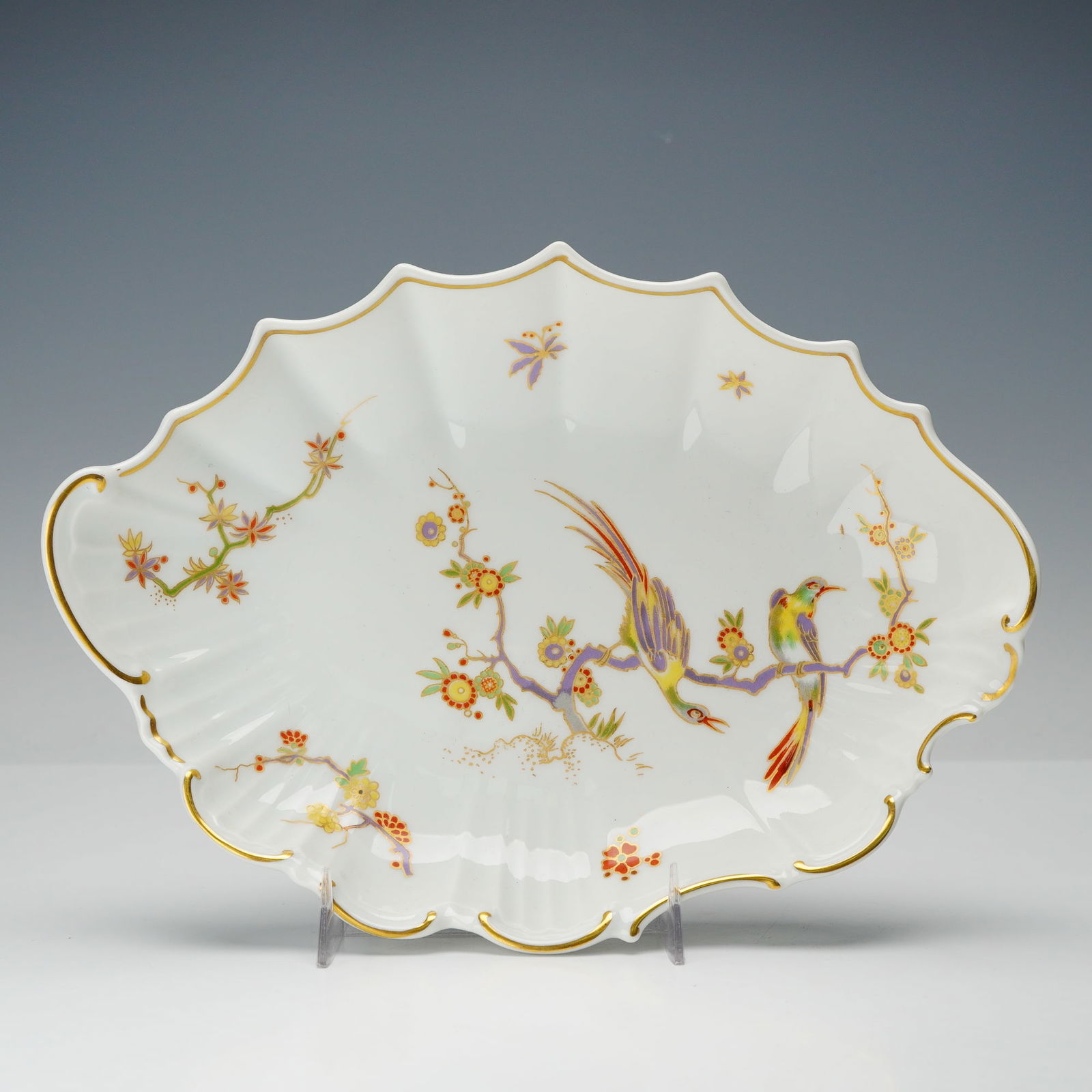 Richard Ginori Porcelain Bowl, Old Milan: This bowl features a scalloped white form decorated with colorful cranes on flowering branches and finished with gilt accents along the rim. Richard Ginori backstamp. Marked Italy. Dimensions: 9.5"L x