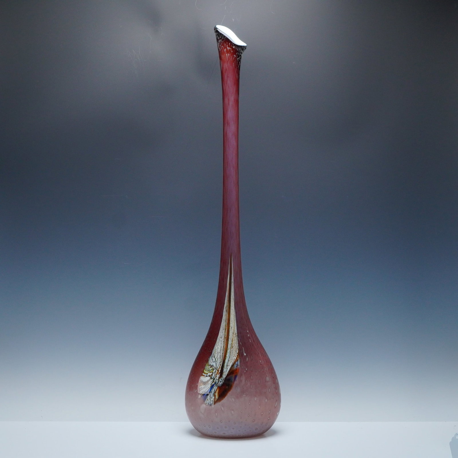 Mauve Tear Drop Art Glass Floor Vase: An elongated, tapering neck rising from a rounded base, executed in a rosy-mauve hue with evenly spaced controlled bubbles throughout the body. The front displays an internal abstract multicolor desig