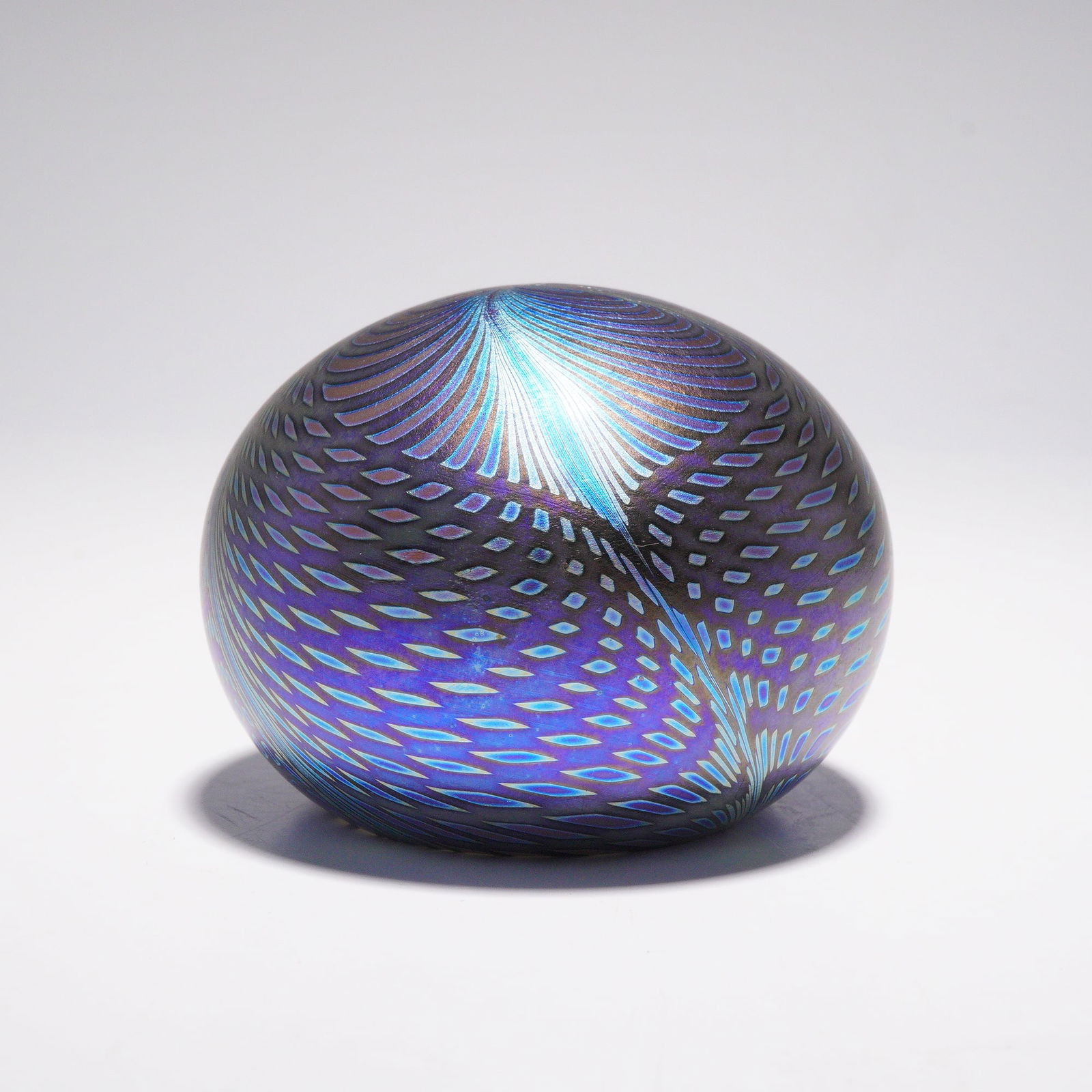 David Lotton for Charles Lotton Studios Art Glass Web Pattern Paperweight: Formed as a spherical paperweight, the piece features David Lotton's web pattern with layered pulled canes arranged in a radiating configuration around the surface. Iridescent coloration shifts across