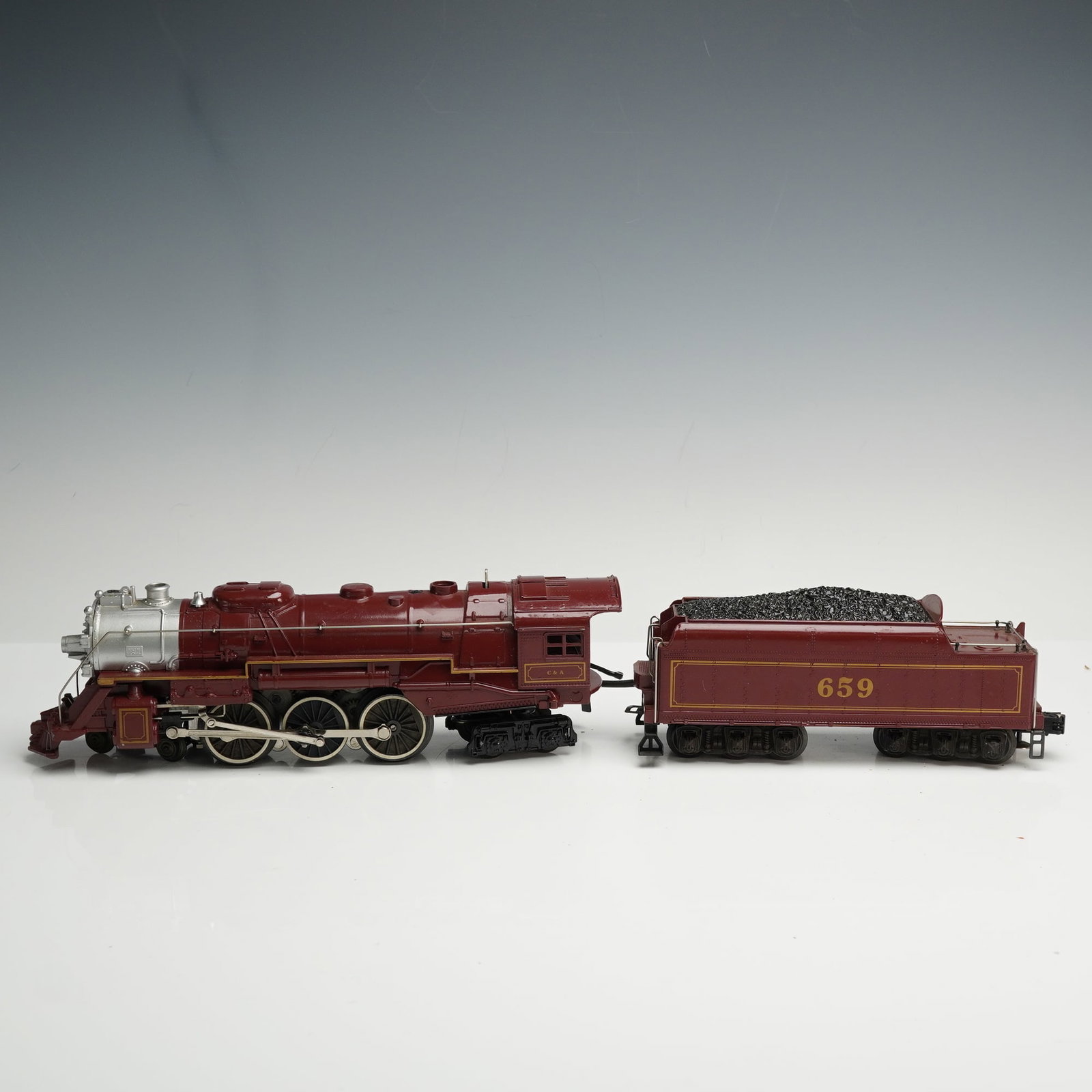 Lionel O and O27 Gauge Hudson Steam Locomotive and Die-Cast Tender: Lionel O and O27 Gauge Chicago & Alton 4-6-4 Hudson Steam Locomotive and Tender, No. 659. This die-cast metal locomotive and tender set was produced by Lionel in Mt. Clemens, Michigan, and is finished