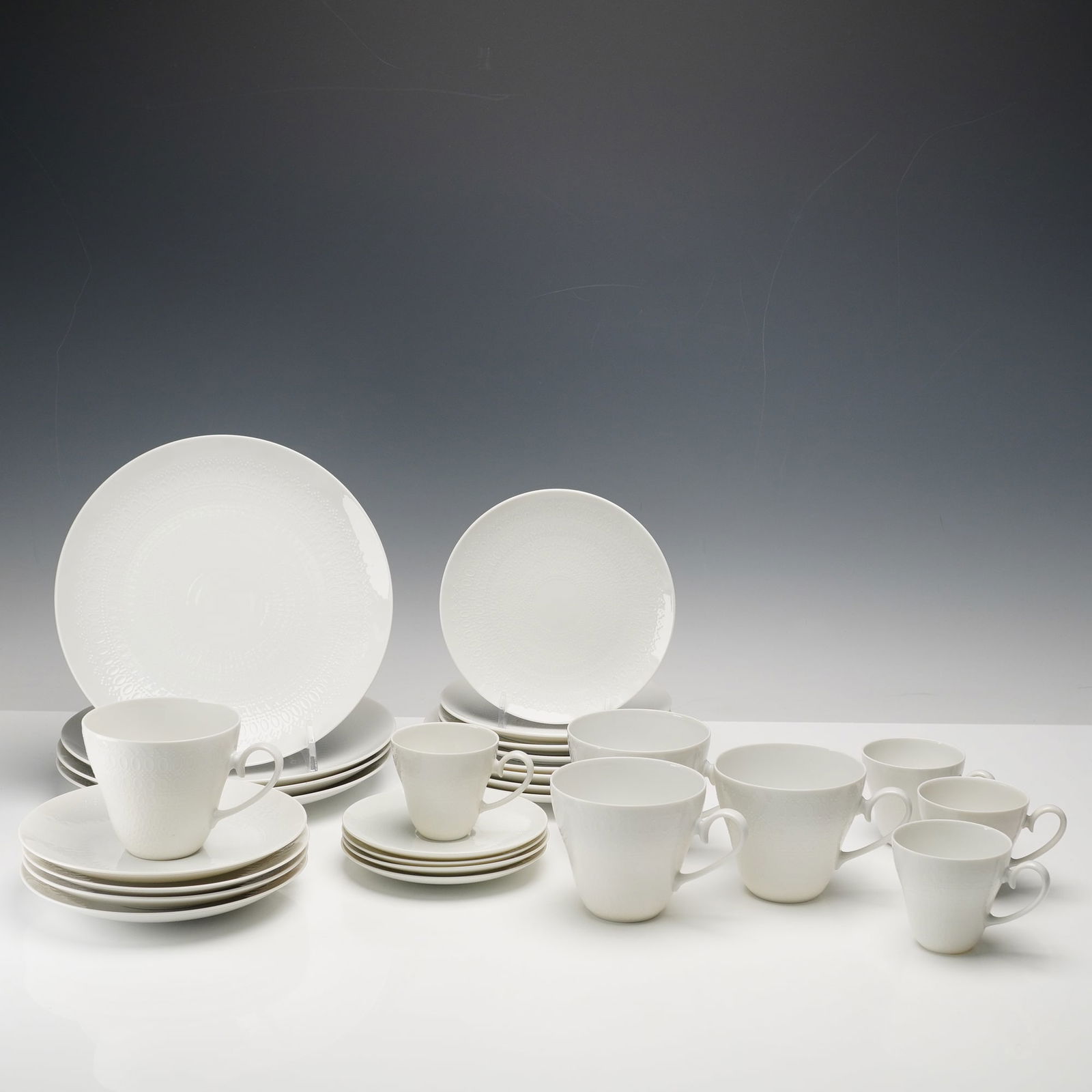 28pc Rosenthal Porcelain Dinnerware Set, Romance: The Continental Romance pattern featuring a refined white-on-white embossed oval motif with subtle raised detailing. This service showcases Rosenthal's modern Studio Line craftsmanship, balancing mini