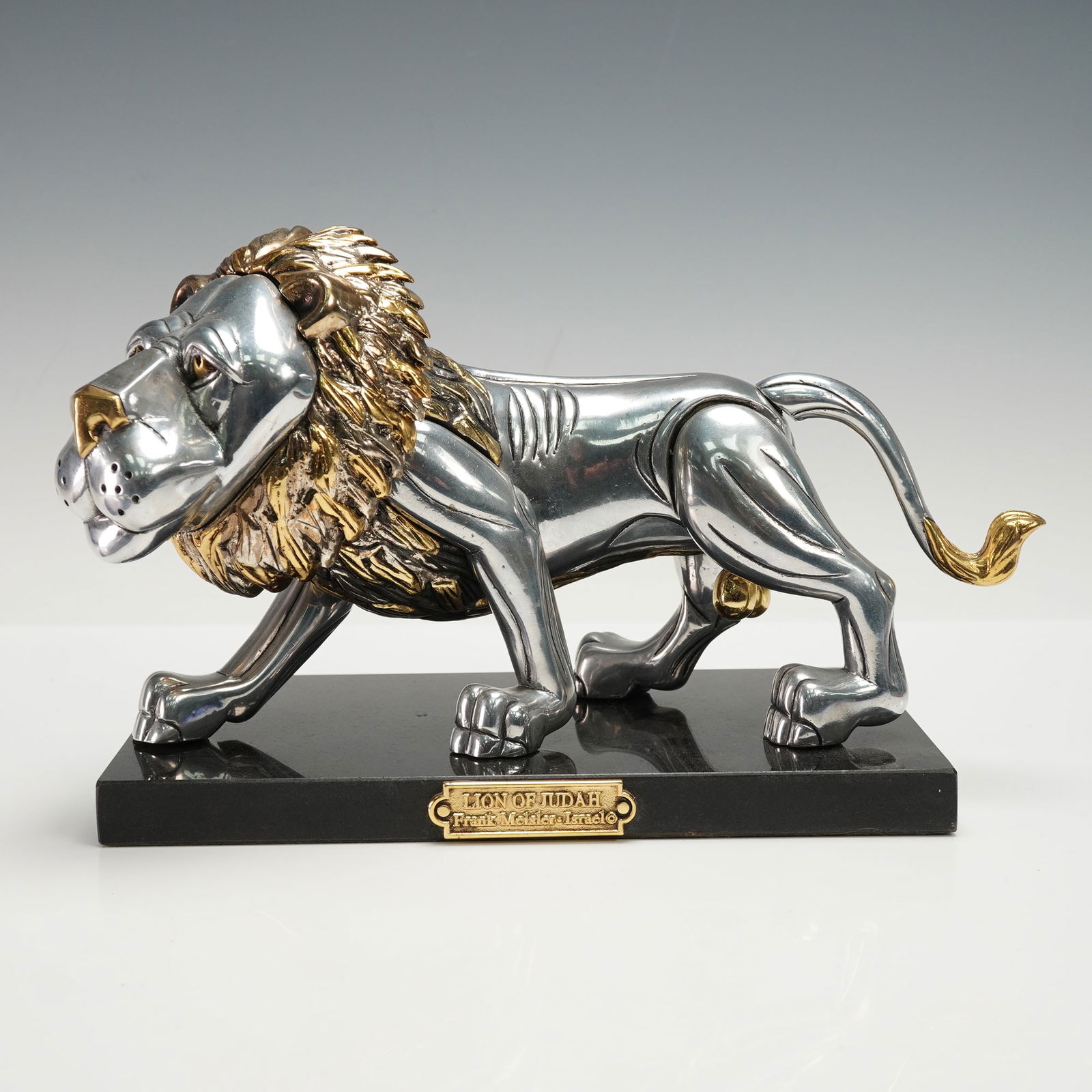 Frank Meisler Lion of Judah Metal Sculpture on Marble Base, Signed: A striking limited-edition Lion of Judah metal sculpture by Israeli artist Frank Meisler. The sculptural lion, rendered in polished silver-tone metal with gilt accents to the mane, tail, and details,