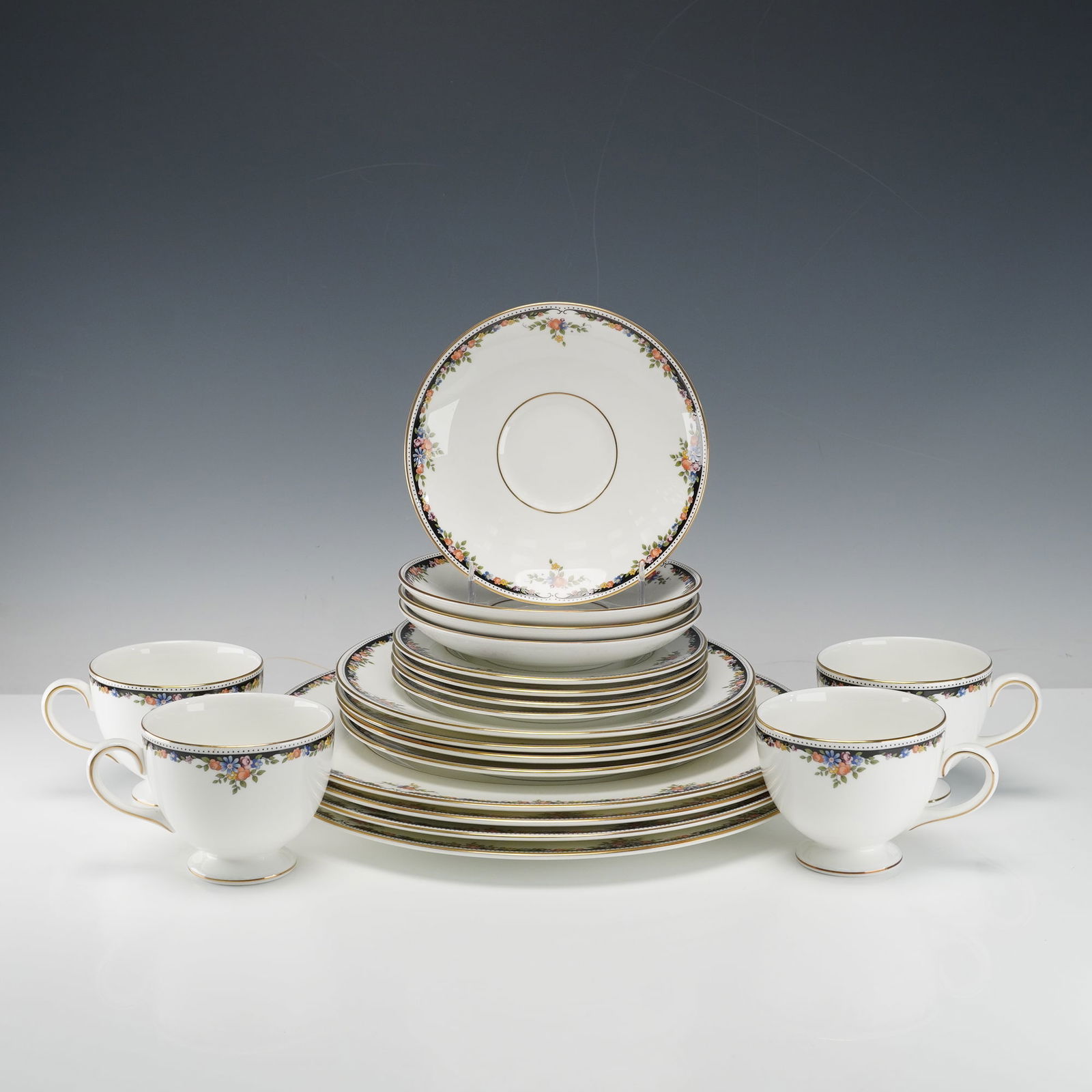 20pc Wedgwood Bone China Dinner Service for Four, Osborne: An elegant 20 piece set for four including 4 dinner plates, 4 salad plates, 4 bread and butter plates, 4 saucers, and 4 leigh footed cups. This pattern features delicate floral garlands encircled with
