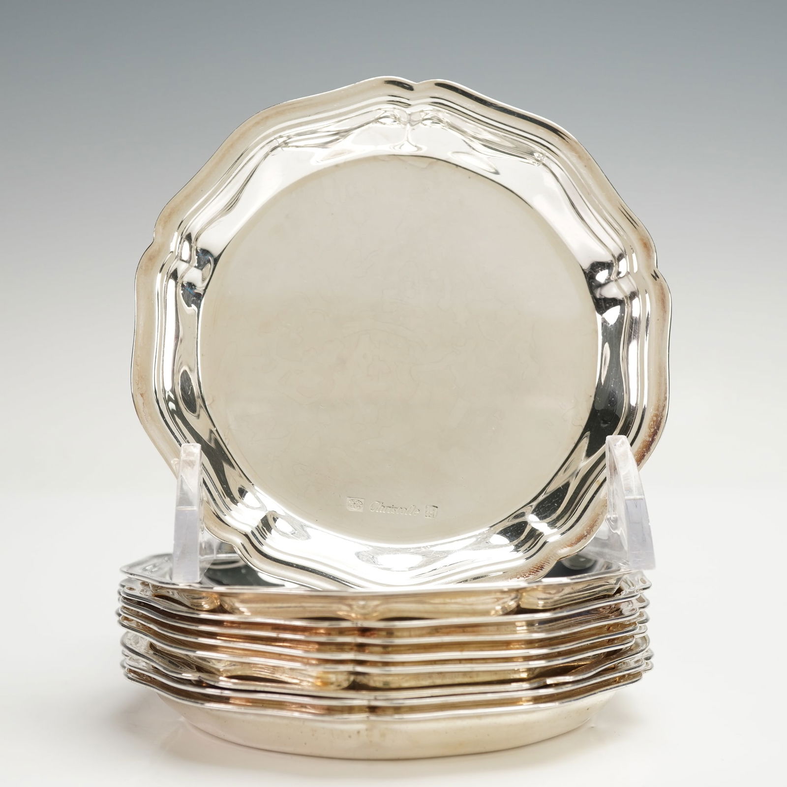 9pc Christofle Silver Plated Coasters, Contours Filet: Each designed with a scalloped border accented by the characteristic filet raised line. The Christofle mark appears on the surface of each coaster. Issued: c. 1950s Dimensions: 0.5"H x 3.5" dia. Count