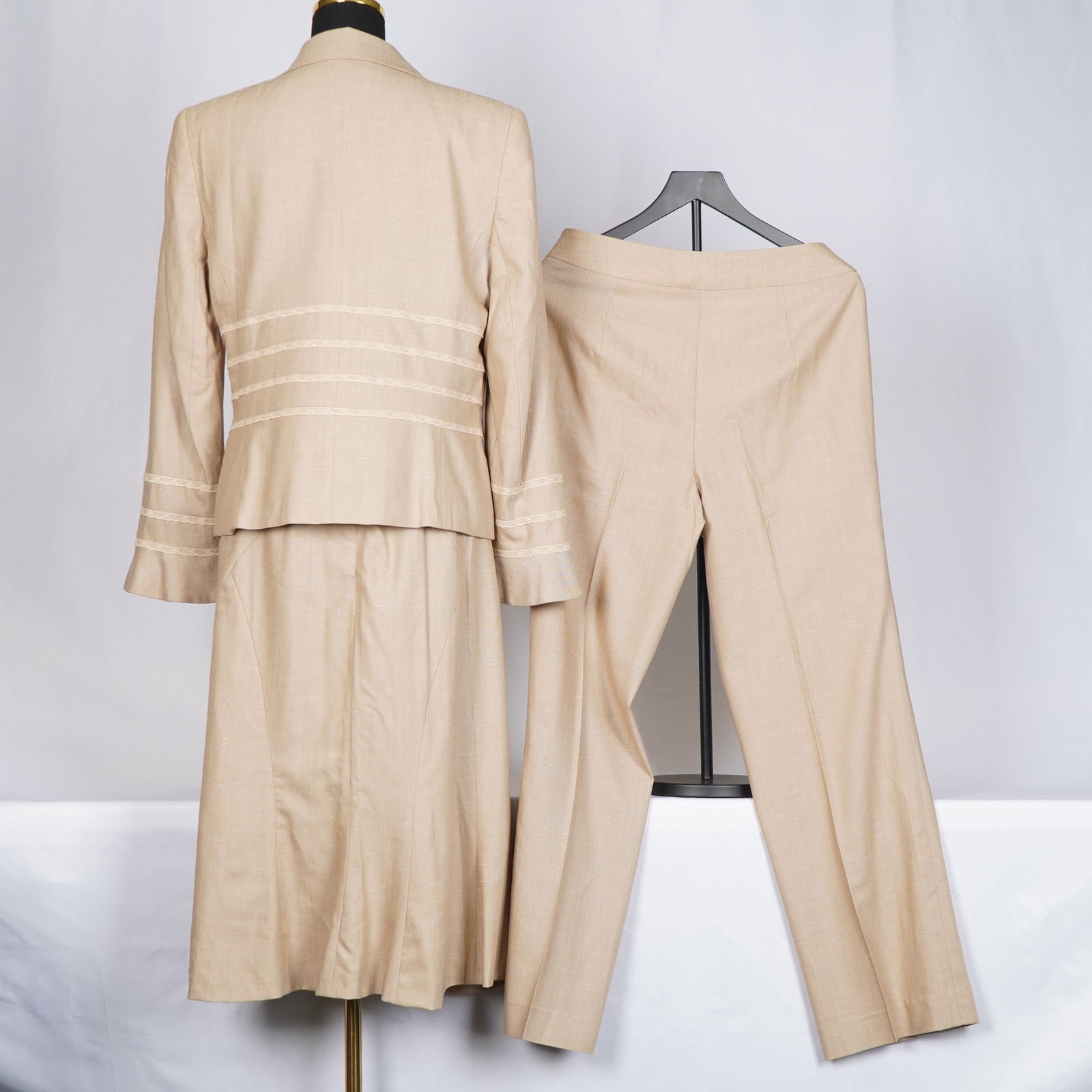 3pc Escada Suit, Beige Linen Blend: Escada three-piece set in a beige linen blend, consisting of a tailored jacket, a matching skirt, and a pair of trousers. The jacket features a notched collar, front button closure, and horizontal lac