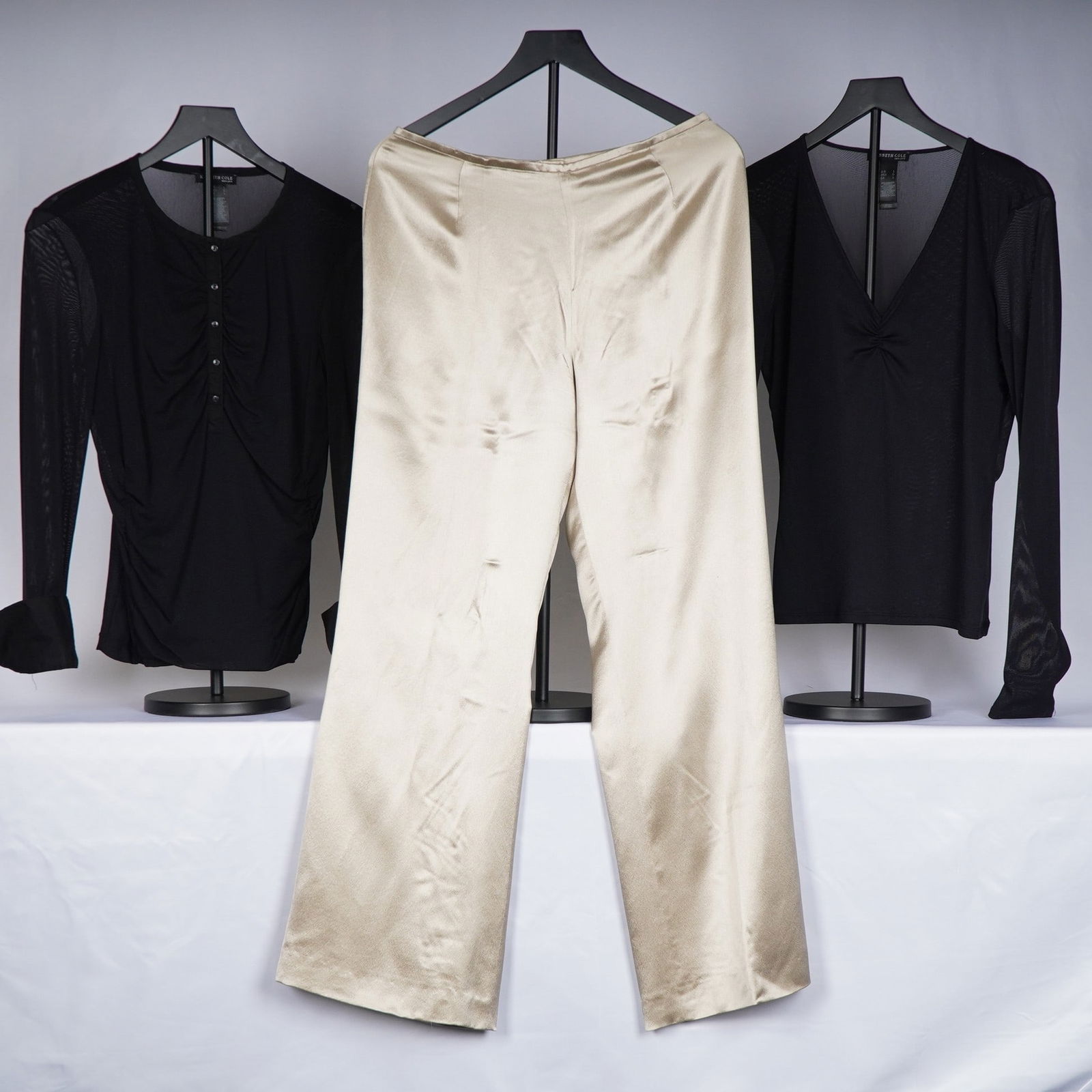 3pc Women's Clothing, Kenneth Cole Black Tops, Escada Silk Pants: A group of three clothing items including two black Kenneth Cole long sleeve tops in size L and one pair of gold Escada pants in size 40. The tops are made of a lightweight sheer knit with varying nec