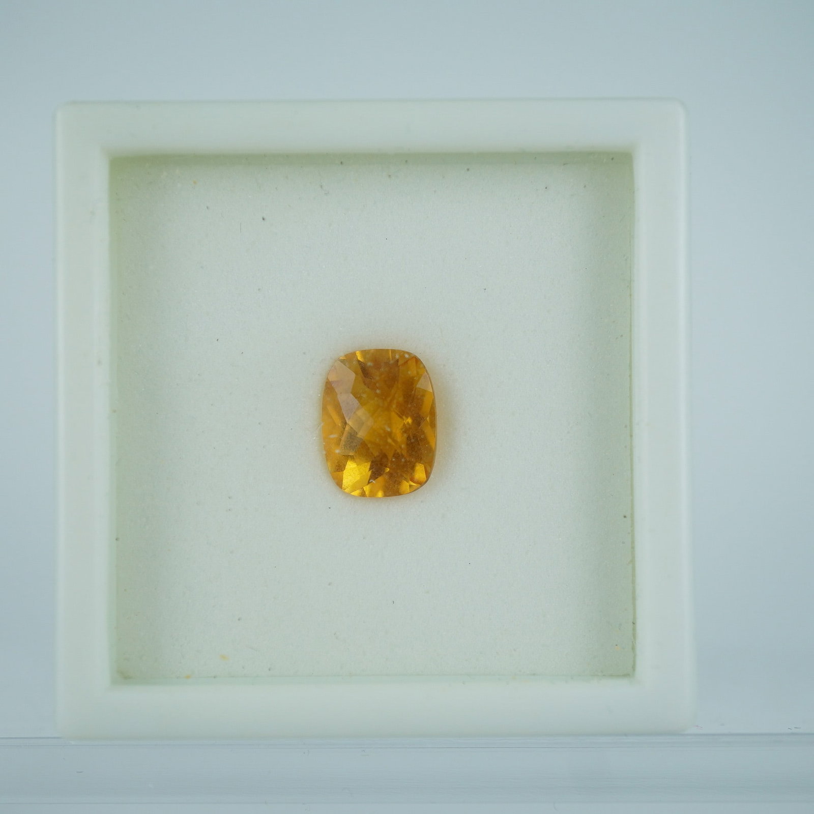 1.90 CT Citrine Cushion Cut Gemstone: This luminous citrine gemstone weighs approximately 1.90 carats and features a classic cushion cut with vibrant golden-yellow tones. Its brilliance and clarity make it a beautiful option for both mode