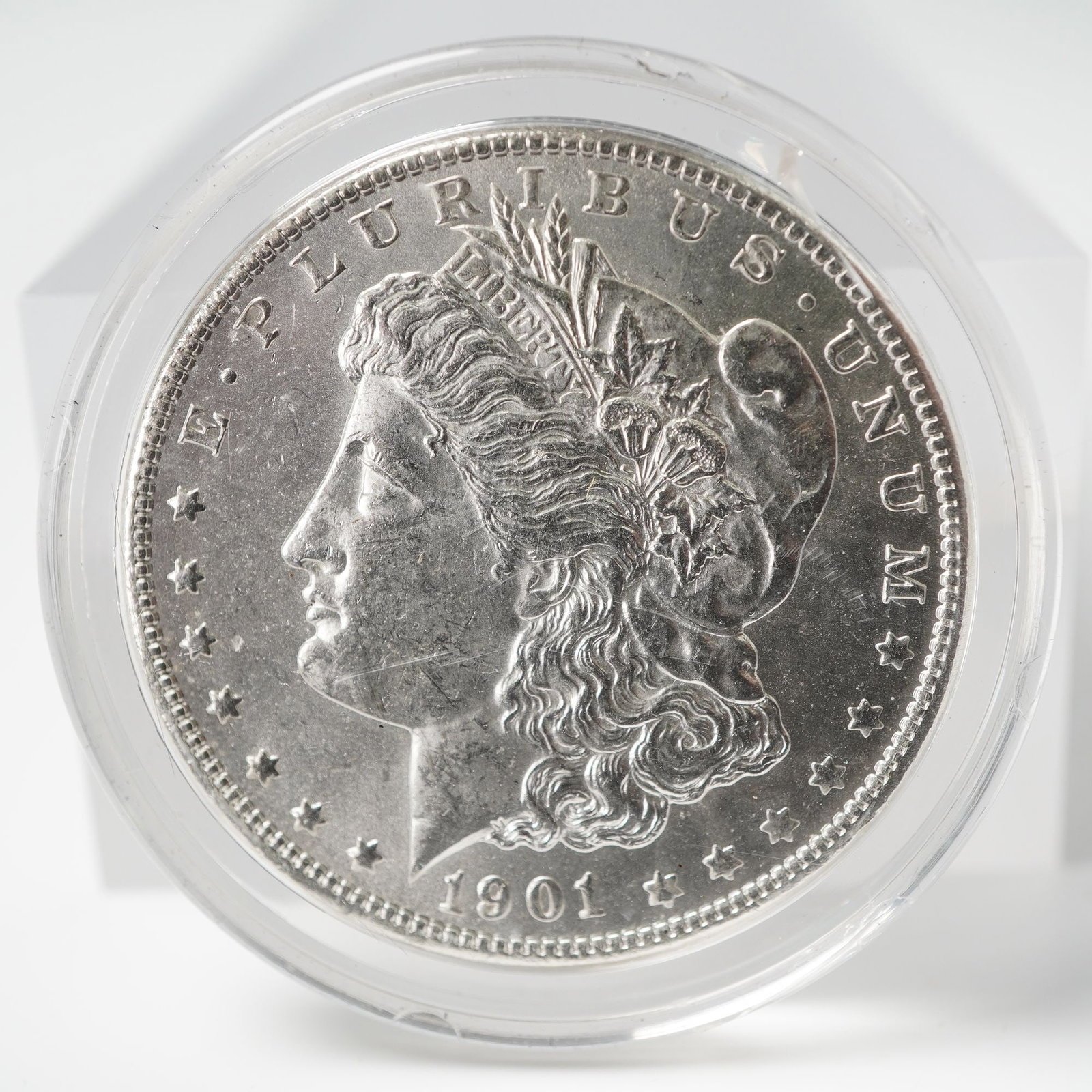 1901-O Morgan Silver Dollar: An obverse, depicting Lady Liberty wearing a Phrygian cap adorned with wheat and cotton, with the inscriptions E PLURIBUS UNUM and the date 1901. The reverse displays a heraldic eagle clutching arrows