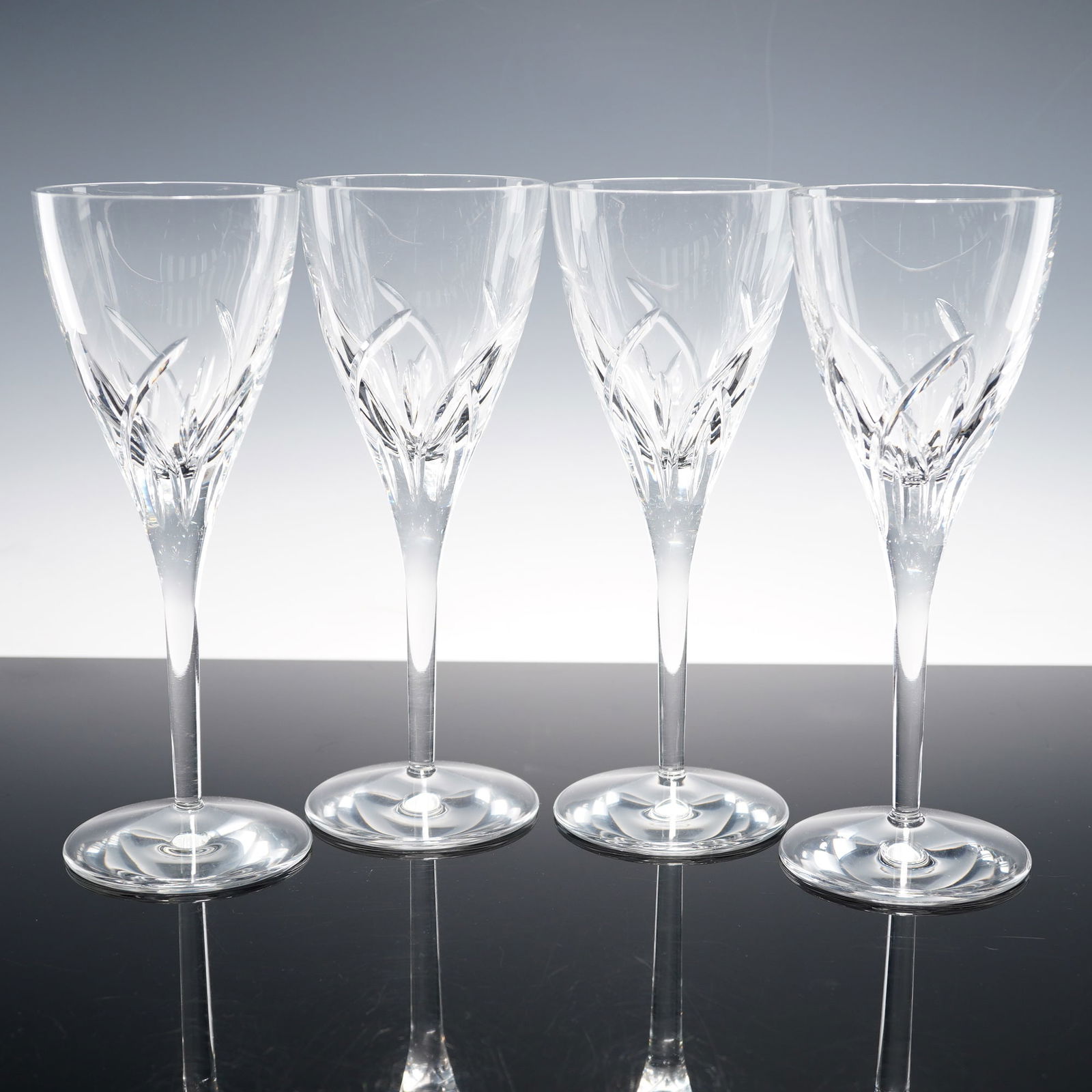 4pc Waterford Crystal Wine Glasses, Merrill: Set of four wine glasses in the Merrill pattern featuring overlapping upward cuts resembling stylized blades rising from the lower bowl to a clear upper section. Each is set on a tapering stem and cir