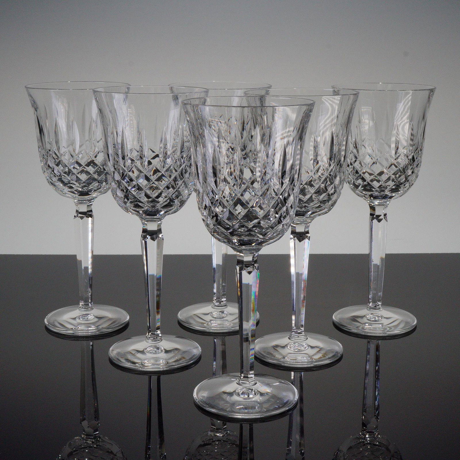 6pc Waterford Crystal Wine Glasses, Kelsey: This set includes six Waterford crystal wine glasses in the Kelsey pattern, featuring a faceted stem and cut bowl design. Each glass carries the Waterford backstamp on the base. Issued: 1995-2018 Dime