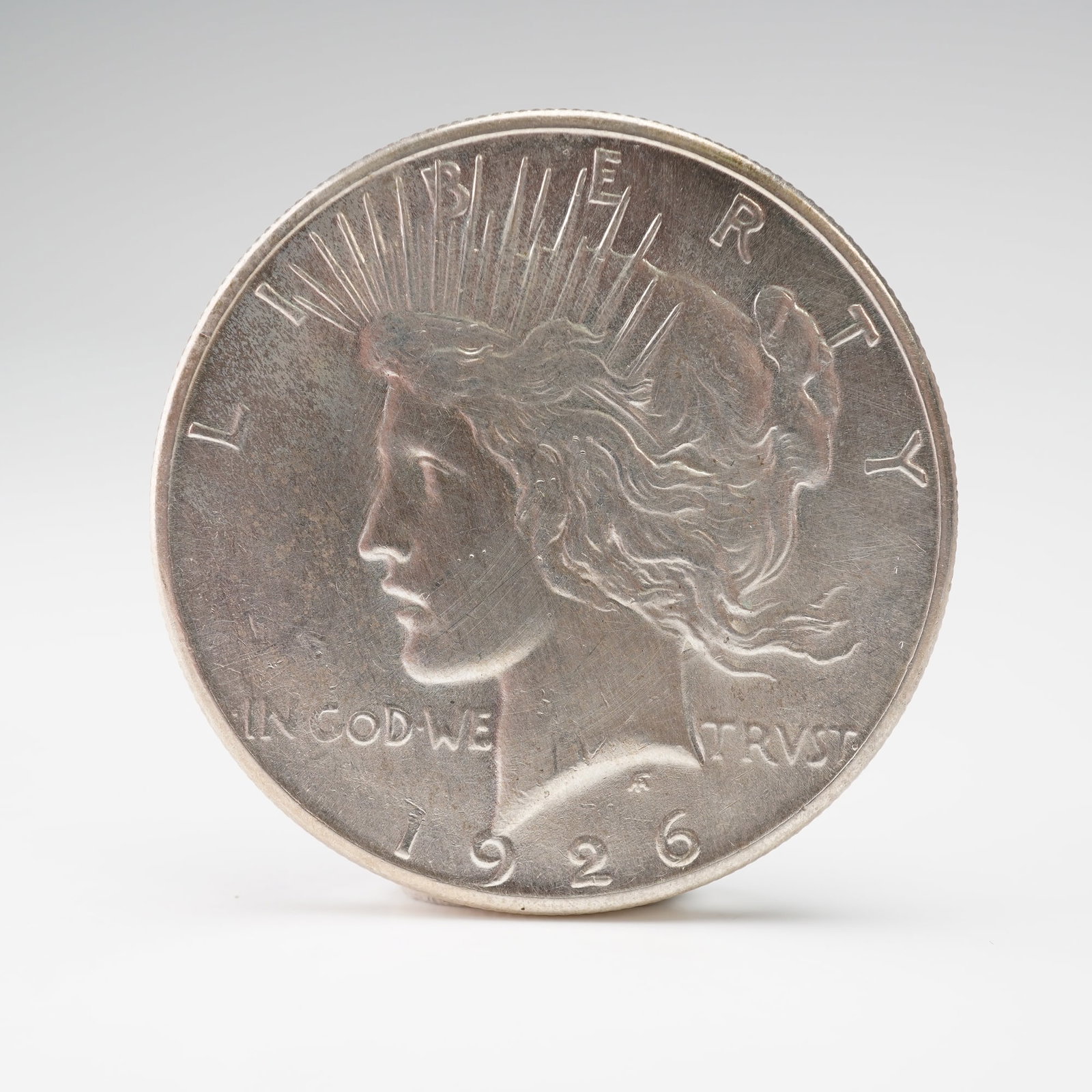 1926-S Peace Dollar: Struck at the San Francisco mint, this peace dollar features the left-facing portrait of Liberty wearing a radiant crown on the obverse, with the inscriptions LIBERTY, IN GOD WE TRVST, and the date 19