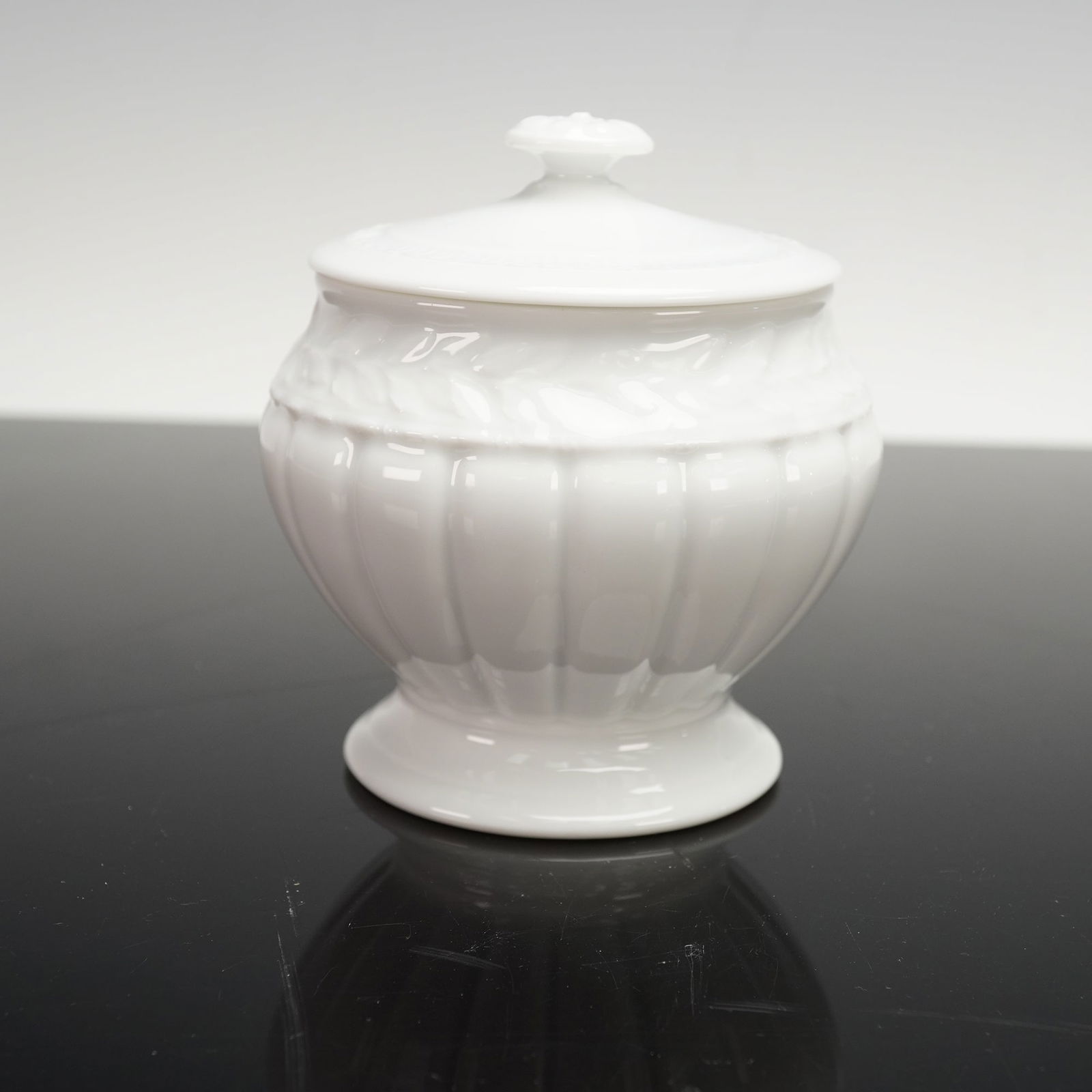 Bernardaud White Porcelain Covered Sugar bowl, Louvre: This white porcelain covered jar by Bernardaud Limoges is part of the Louvre collection, a line whose engraved motifs form a catalogue of French architectural styles from the Renaissance through the S