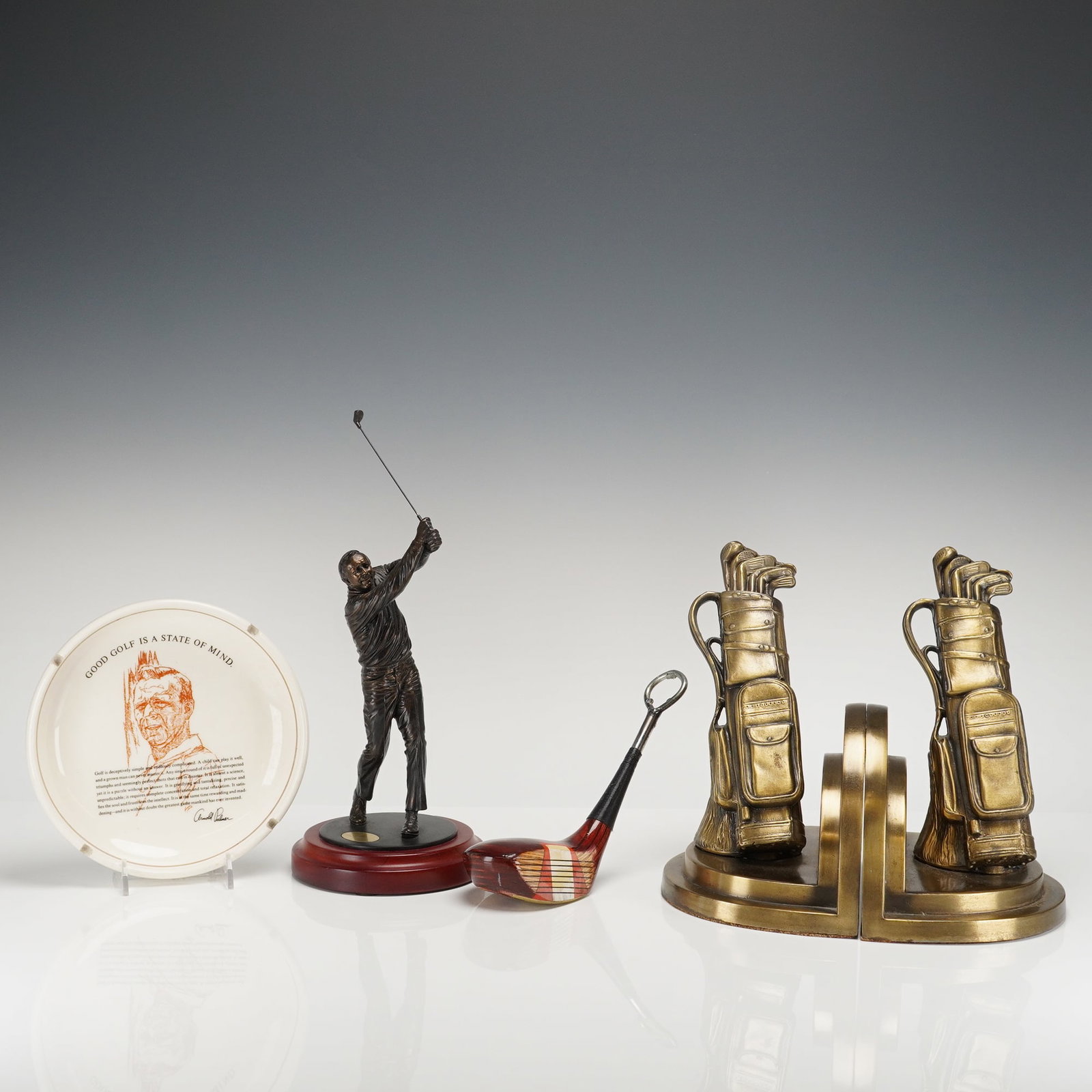 A Collection of 5 Vintage Arnold Palmer and Golf Memorabilia Items: This collection comprises five (5) pieces of vintage gold themed golf memorabilia, primarily focused on the legendary golfer Arnold Palmer. The grouping includes a bronze-toned figurine, likely a Wanb