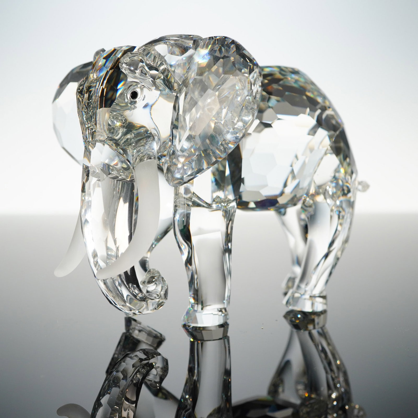 Swarovski Crystal Annual Edition Figurine, The Elephant: An SCS Annual Edition 1993 Inspiration Africa The Elephant crystal figurine. This contemporary elephant figurine is crafted from clear, faceted crystal, exhibiting a modern aesthetic. Its body, head,