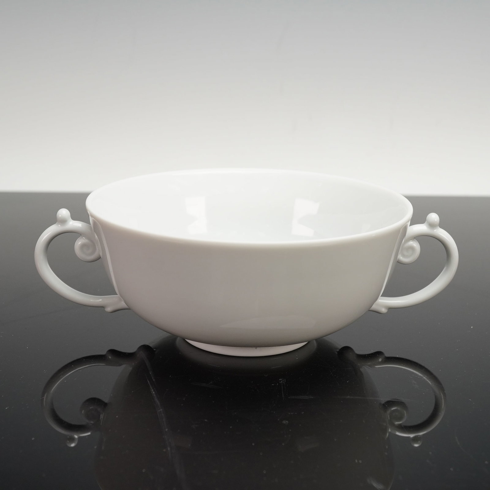 L'Objet Flat Cream Soup Bowl, Aegean White: Inspired by the Greco-Roman treasures of the ancient world, Aegean is a dinnerware collection made from Limoges porcelain. The name is derived from the Greek word aiges, which means waves. Stamped on