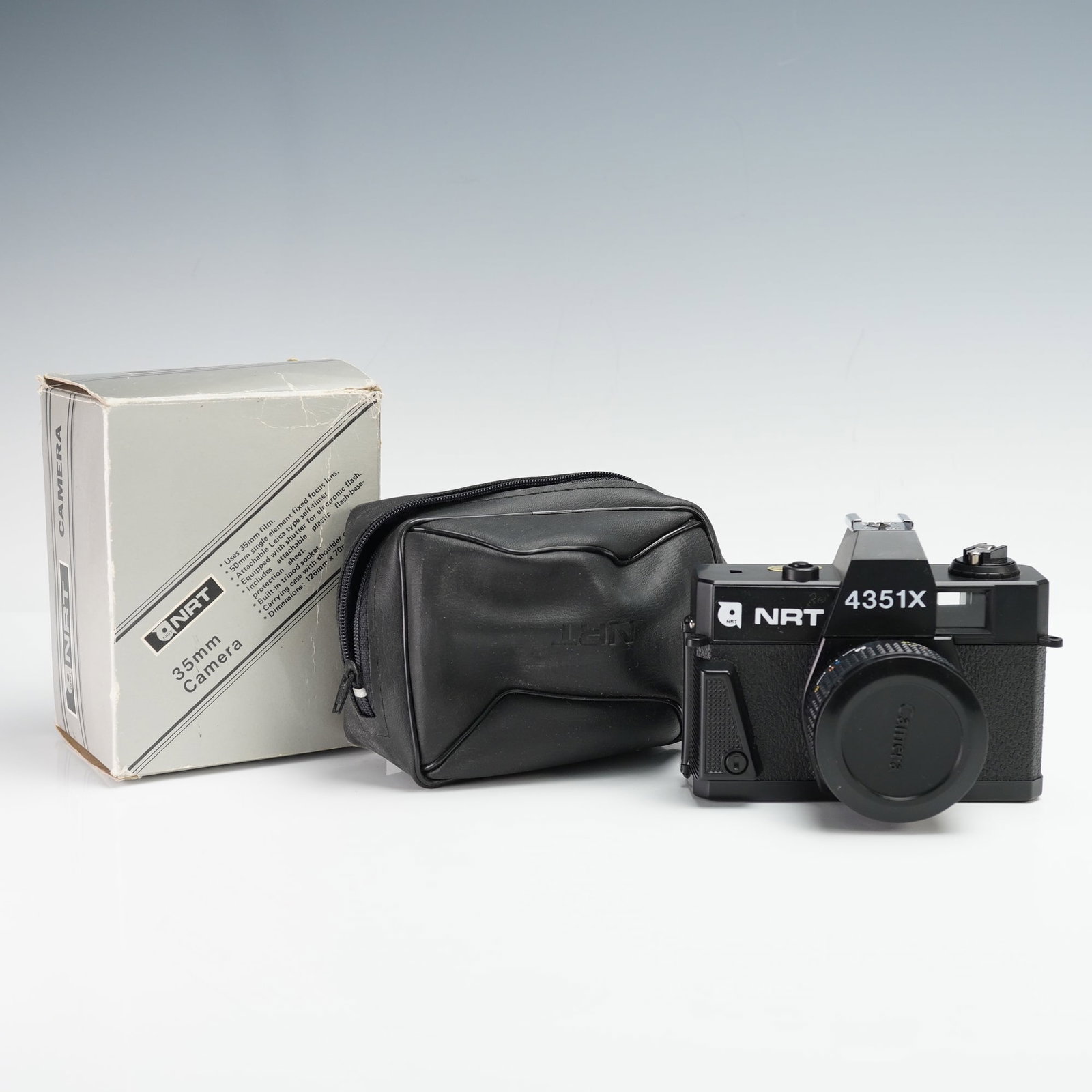 NRT 4351X 35mm Film Camera with Case: This NRT 4351X 35mm film camera features a fixed-focus 50mm lens and a sleek black design. It includes the original lens cap, case, and packaging. The camera operates with 35mm film, and the serial nu