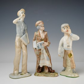Three Spanish Glazed Porcelain Figural Statuettes of Newspaper Sellers