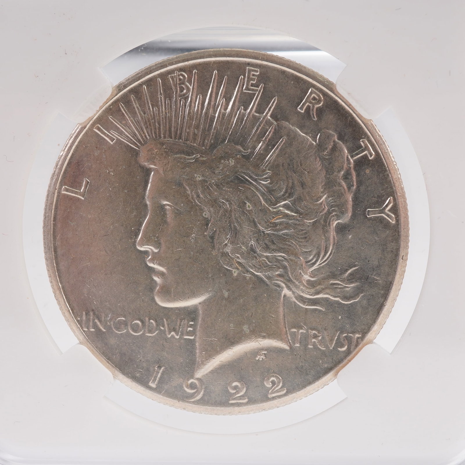 1922 (P) Liberty Silver Peace Dollar: United States, 1922. Silver Peace Dollar, struck at the Philadelphia Mint, designed by Anthony de Francisci. The obverse features the head of Lady Liberty facing left, adorned with a radiant crown, wi