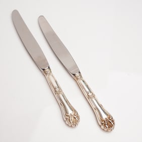 A Pair of Rococo Revival Sterling Silver and Stainless Steel Dinner Knives