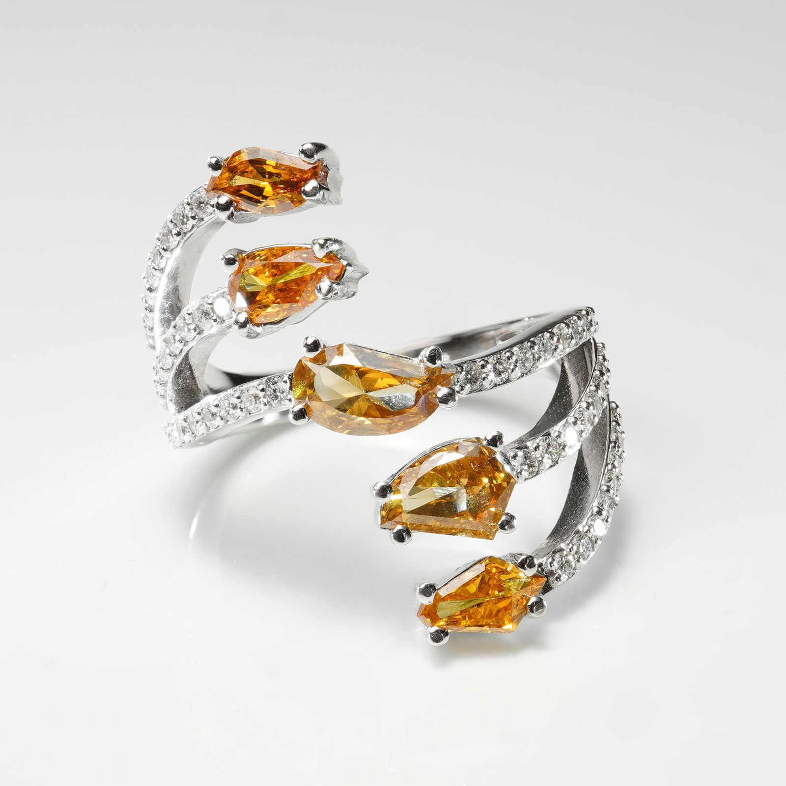 18k White Gold 1.48ctw Orange-Yellow Diamond & 0.39ctw White Diamond Ring: This exquisite ring features five multi-shaped orange-yellow diamonds totaling 1.48 carats, their vivid tones radiating warmth and brilliance. They are complemented by 48 round brilliant white diamond