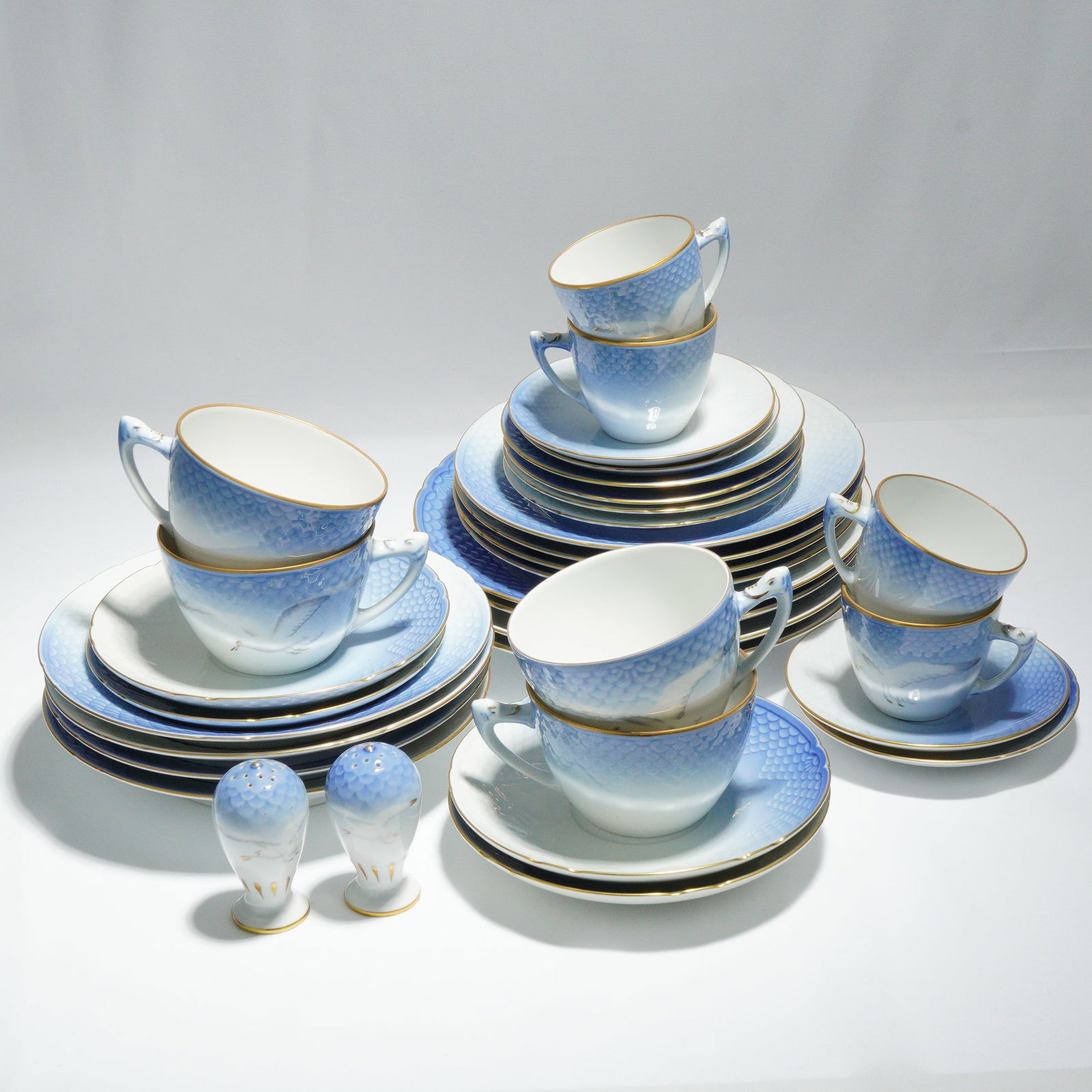 38pc Bing & Grondahl Seagull Pattern Porcelain Dinneware: A substantial porcelain dinner service by Bing & Grondahl, in the Seagull pattern. The service comprises numerous cups, saucers, and various sized plates, along with a pair of matching salt and pepper