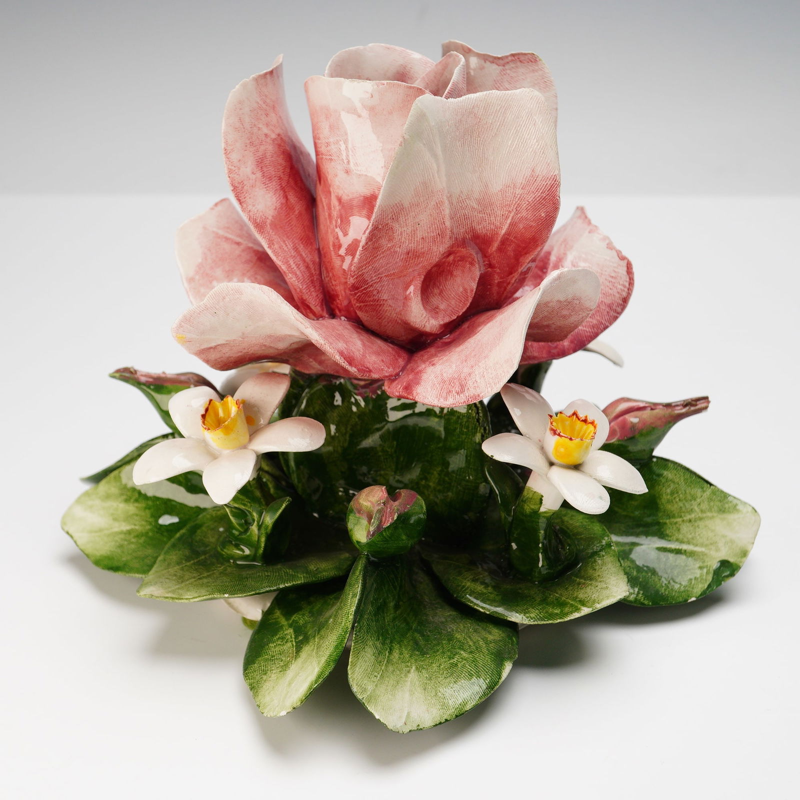 Capodimonte Pink Rose Candle Holder: Exquisitely crafted Italian porcelain floral arrangement featuring a large pink rose surrounded by delicate white blossoms and lush green leaves, designed as a candle holder. Finely detailed and hand-
