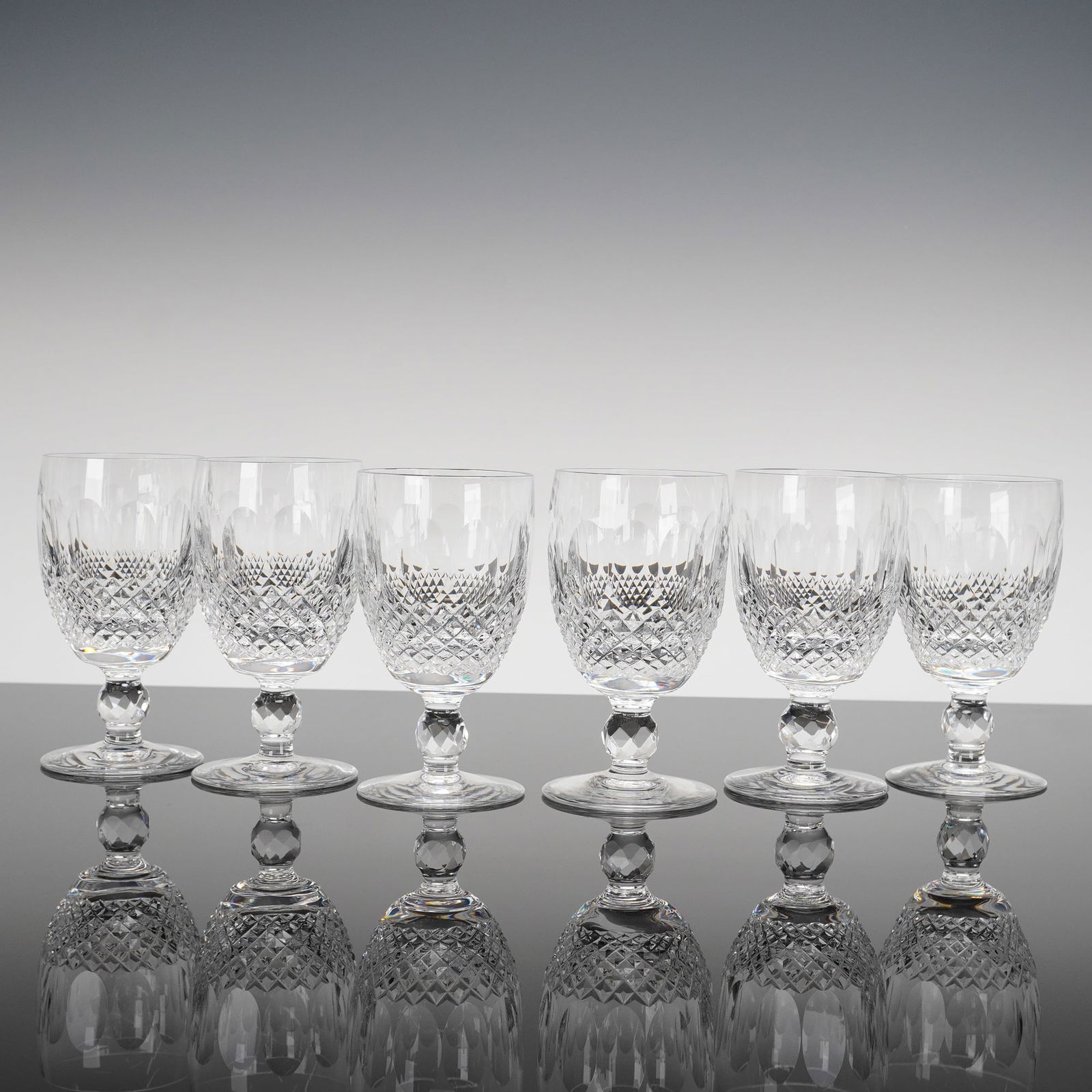 Six Waterford Crystal Colleen Short Stem Claret Wine Glasses: A collection of six Waterford Crystal stemmed wine glasses in the Colleen pattern, featuring the short stem variation. Each glass is crafted from heavy, clear colorless crystal. The bowl is deeply cut