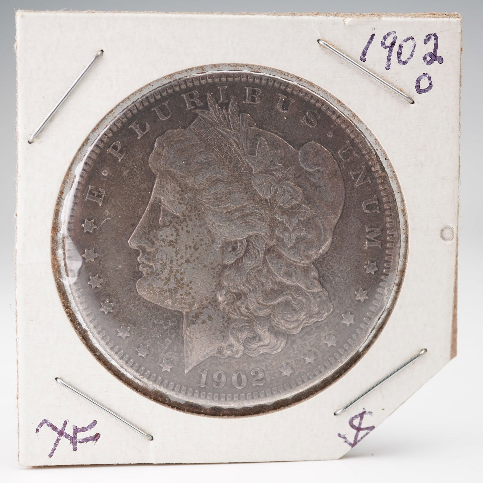 1902-O Morgan Silver Dollar: A 1902-O Morgan Silver Dollar struck at the New Orleans Mint, representing one of the later issues in the celebrated Morgan series designed by George T. Morgan. The obverse features the familiar bust