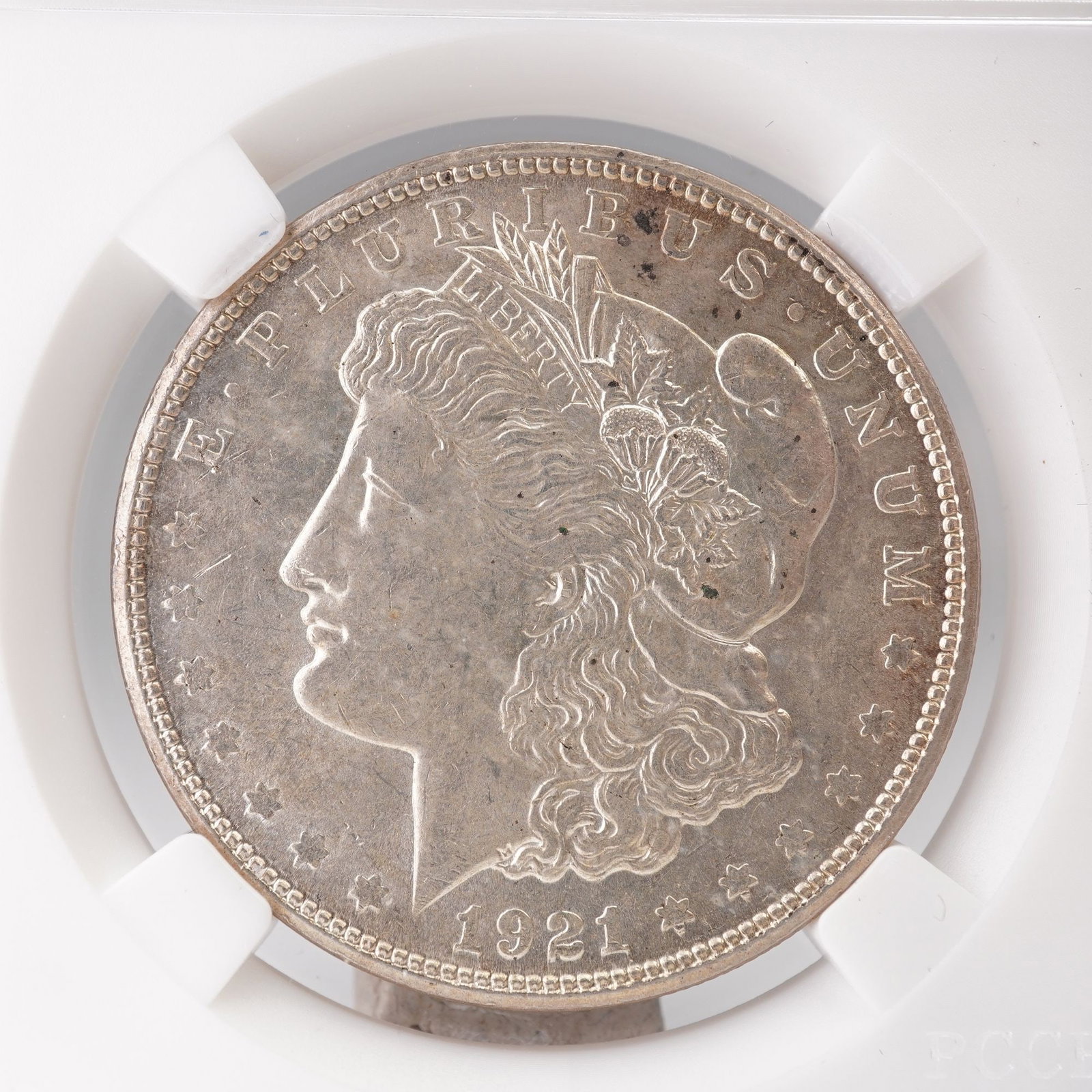 1921-S Morgan Silver Dollar: A 921-S Morgan Silver Dollar, struck at the San Francisco Mint and composed of ninety percent silver. The obverse exhibits the classical left-facing bust of Liberty adorned with a Phrygian cap and agr