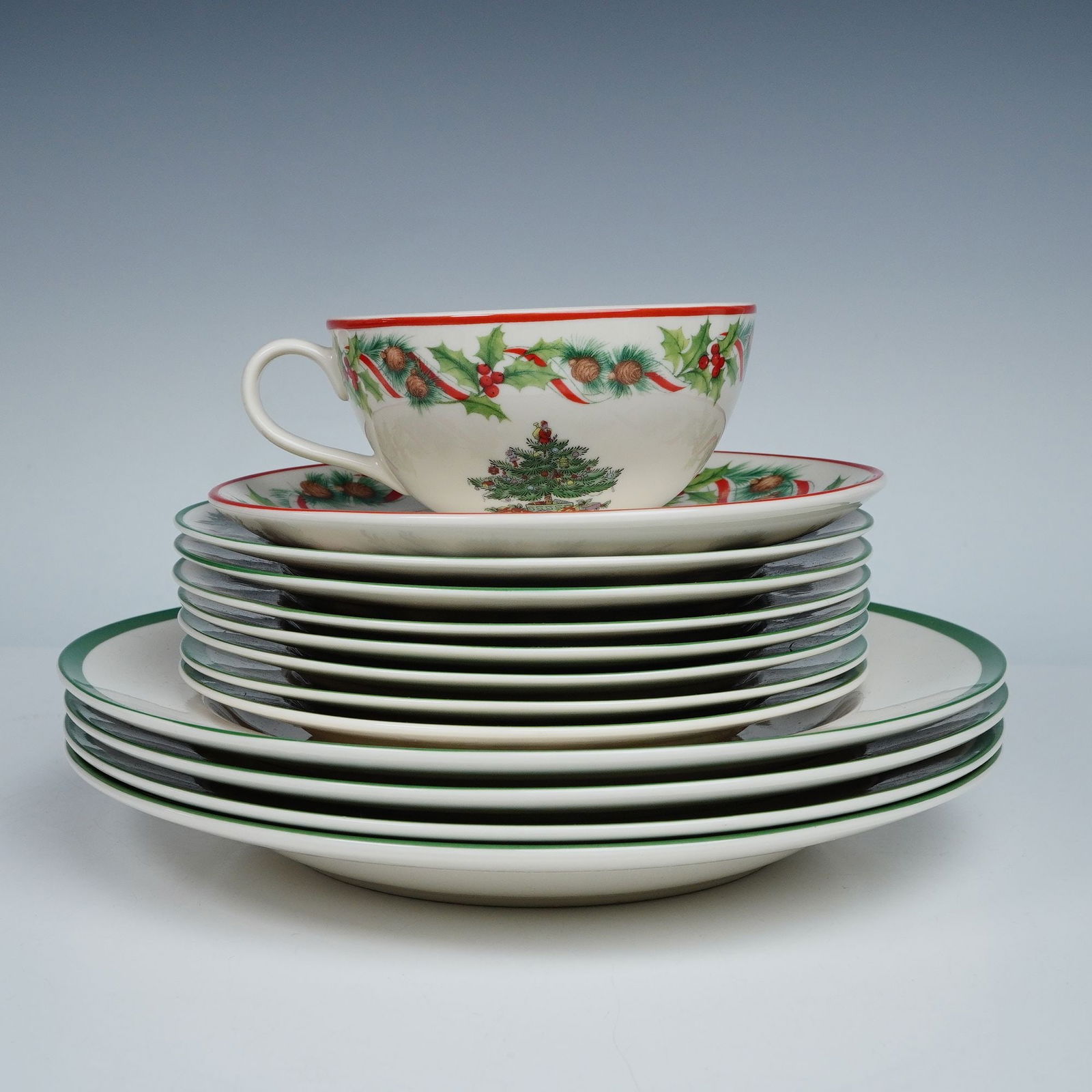 13pc Spode Christmas Tree Dinner and Salad Set with Cup and Saucer: Festive and timeless, this 13-piece Spode Christmas Tree set captures the joy of the holiday season with its classic evergreen design adorned with ornaments, toys, and holly accents. The collection in