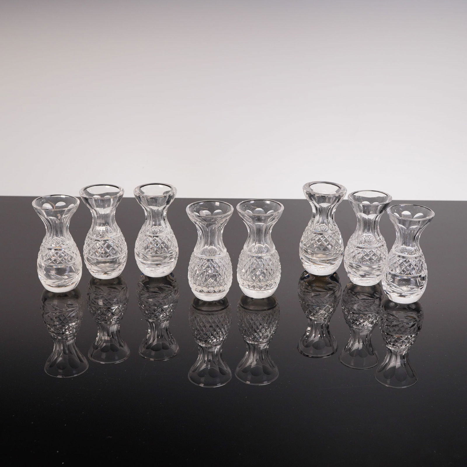 A Collection of Eight Waterford Crystal Glandore Violet Bud Vases: A collection of eight cut crystal vessels identified through consensus as Waterford Crystal Glandore Violet Bud Vases. Each piece is executed in clear polished crystal featuring a classical form. The