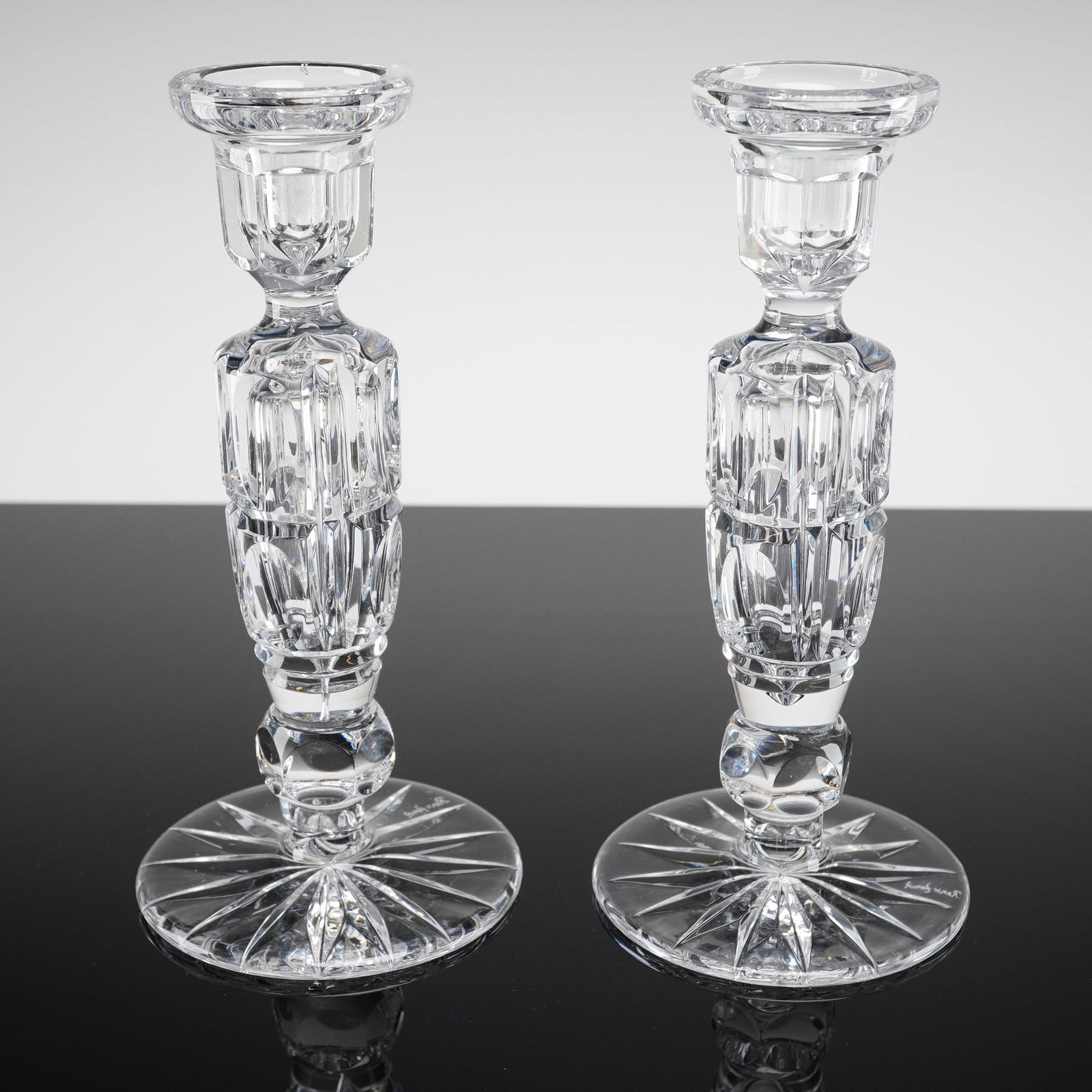A Pair of REXX Full Lead Hand Cut Cameo Crystal Candlesticks: A pair of full lead crystal candle holders attributed to REXX, consistent with the Cameo Cut pattern and the Rexx Foral line. Each candlestick features a columnar stem with deep vertical faceting and