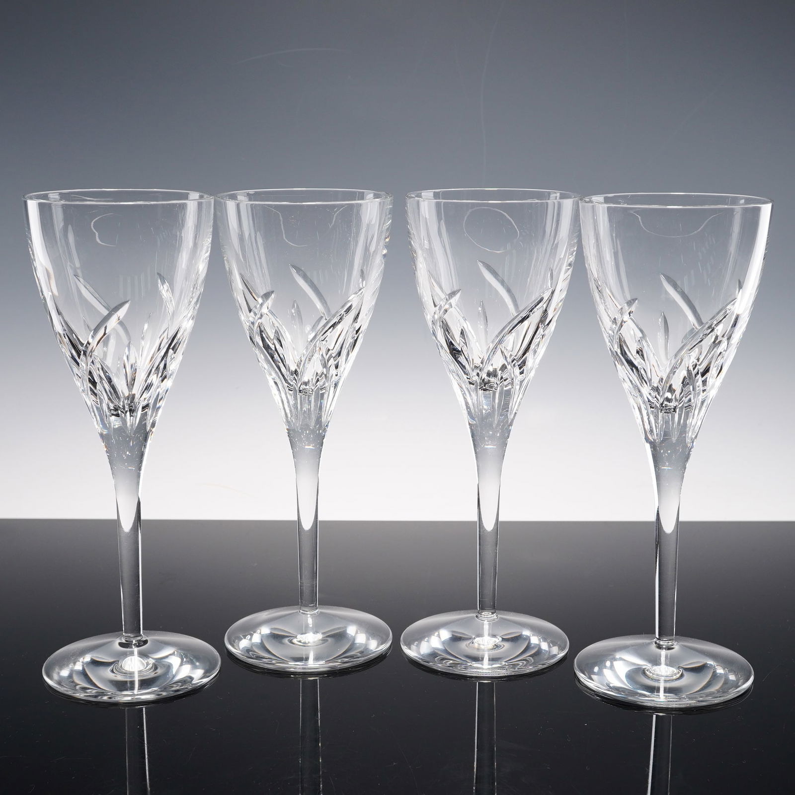 4pc Waterford Crystal Wine Glasses, Merrill: Set of four wine glasses in the Merrill pattern featuring overlapping upward cuts resembling stylized blades rising from the lower bowl to a clear upper section. Each is set on a tapering stem and cir