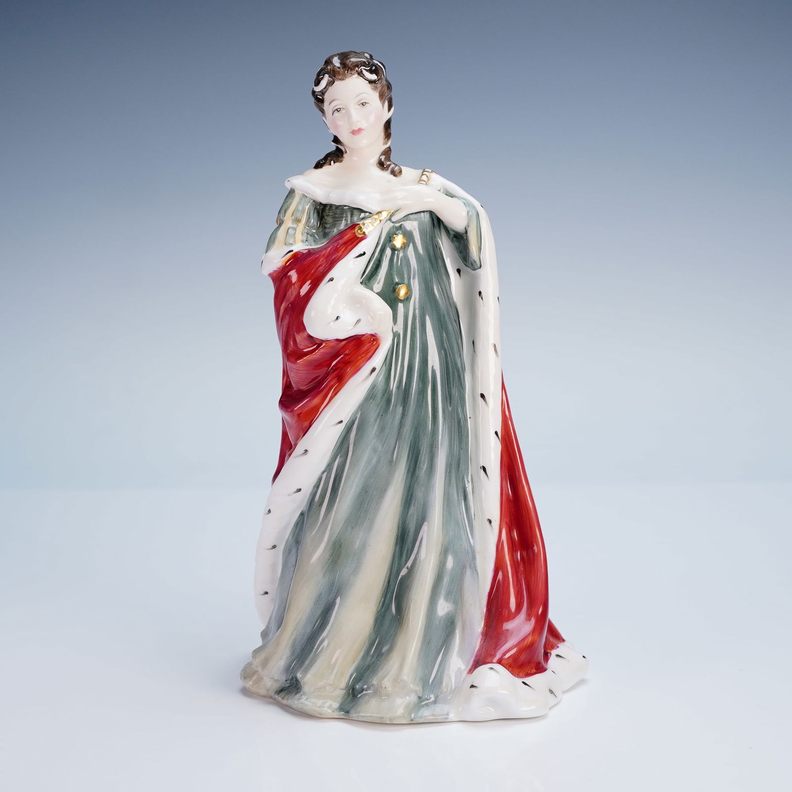 Royal Doulton Figurine, Queen Anne HN3141: This Royal Doulton figurine, titled Queen Anne and numbered HN3141, captures the regal poise of the early 18th-century monarch in exquisite hand-painted detail. Part of the prestigious "Queens of the