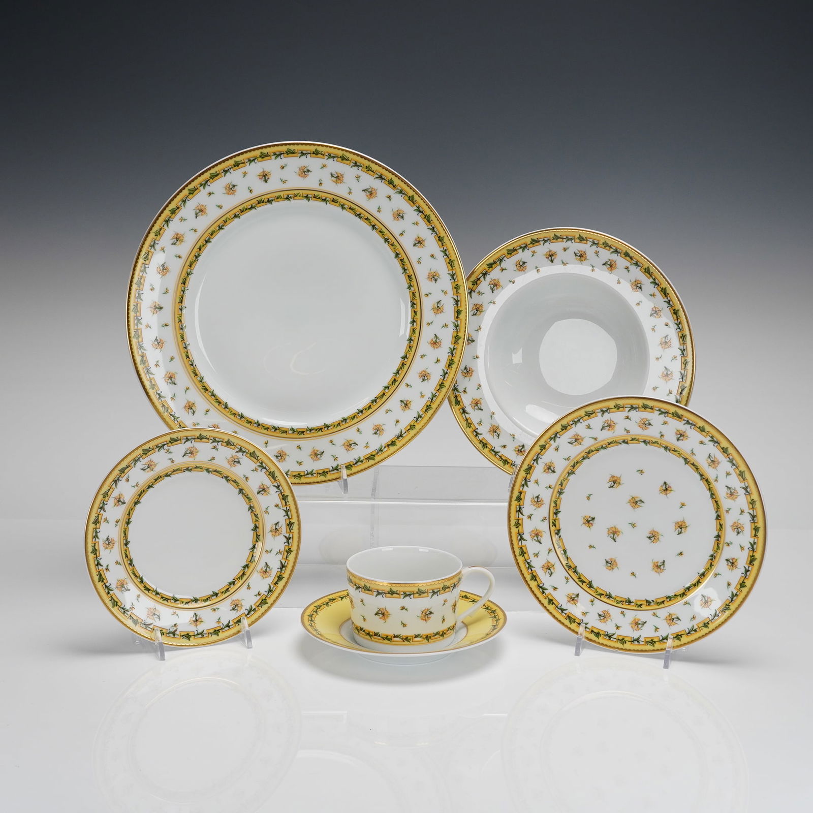 A. Raynaud & Co. French Limoges Porcelain Dinnerware: A collection of six pieces of A. Raynaud & Co. French Limoges porcelain dinnerware in the Bougainville pattern. The set includes one dinner plate, one soup bowl, two salad/dessert plates, one cup, and