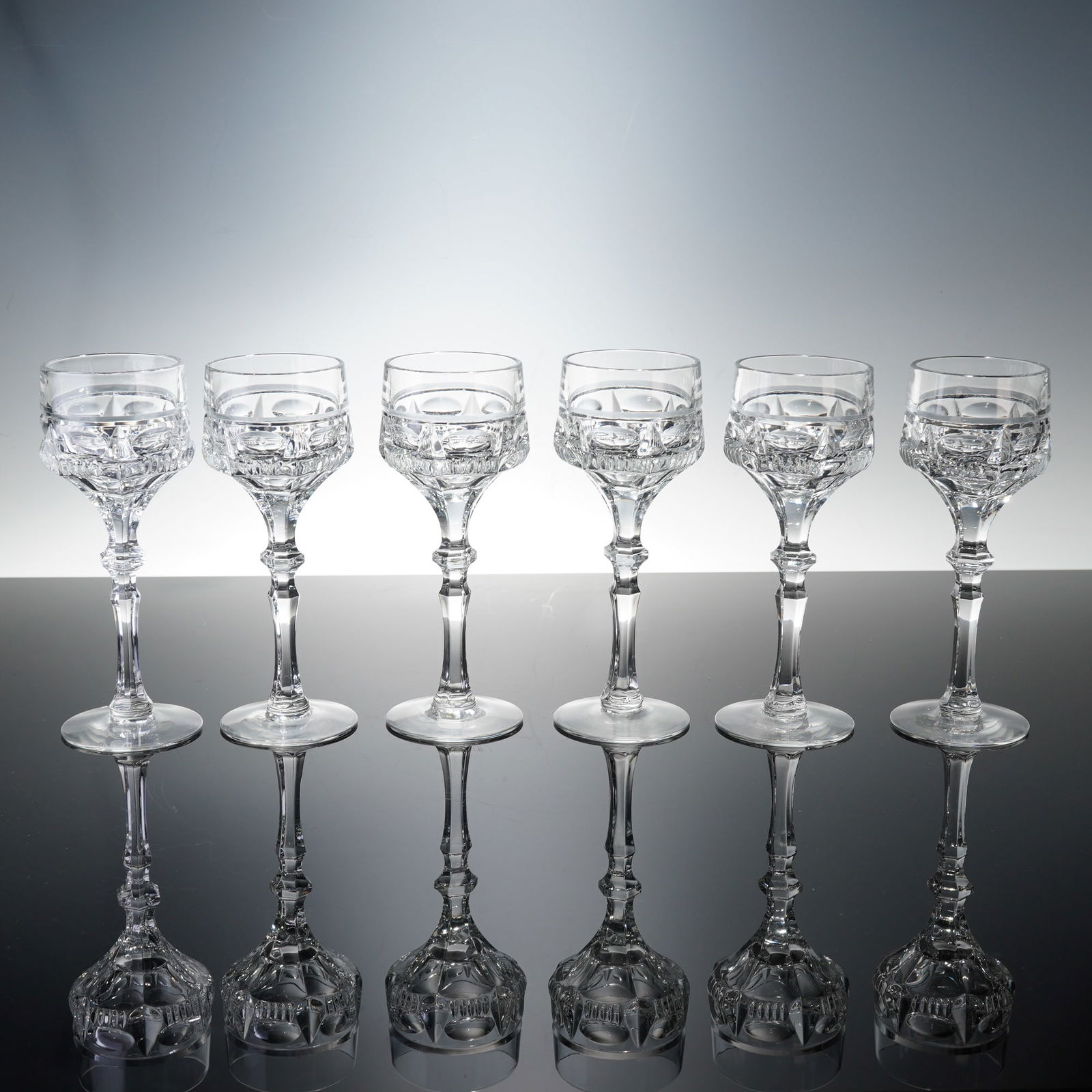 6pc Clear Cut Crystal Wine Glasses: Hand-cut lead crystal wine glasses features deep geometric and oval panel cuts that enhance the brilliance and clarity of the glass. Each stem is finely faceted, tapering gracefully to a broad, polish