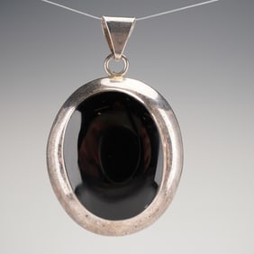 A Mexican Sterling Silver and Black Onyx Oval Pendant