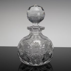 A Cut Crystal Globular Decanter and Stopper, Featuring Floral Motifs